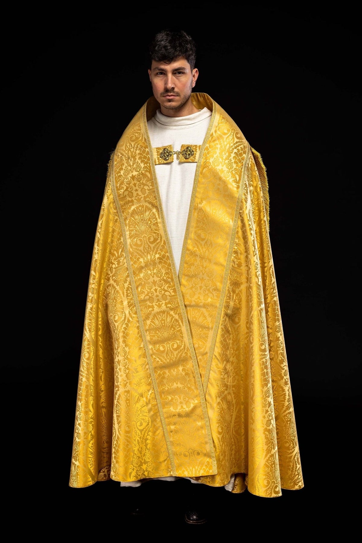 Plain Roman Jacquard Cope front view in gold jacquard with ornate motifs and trim