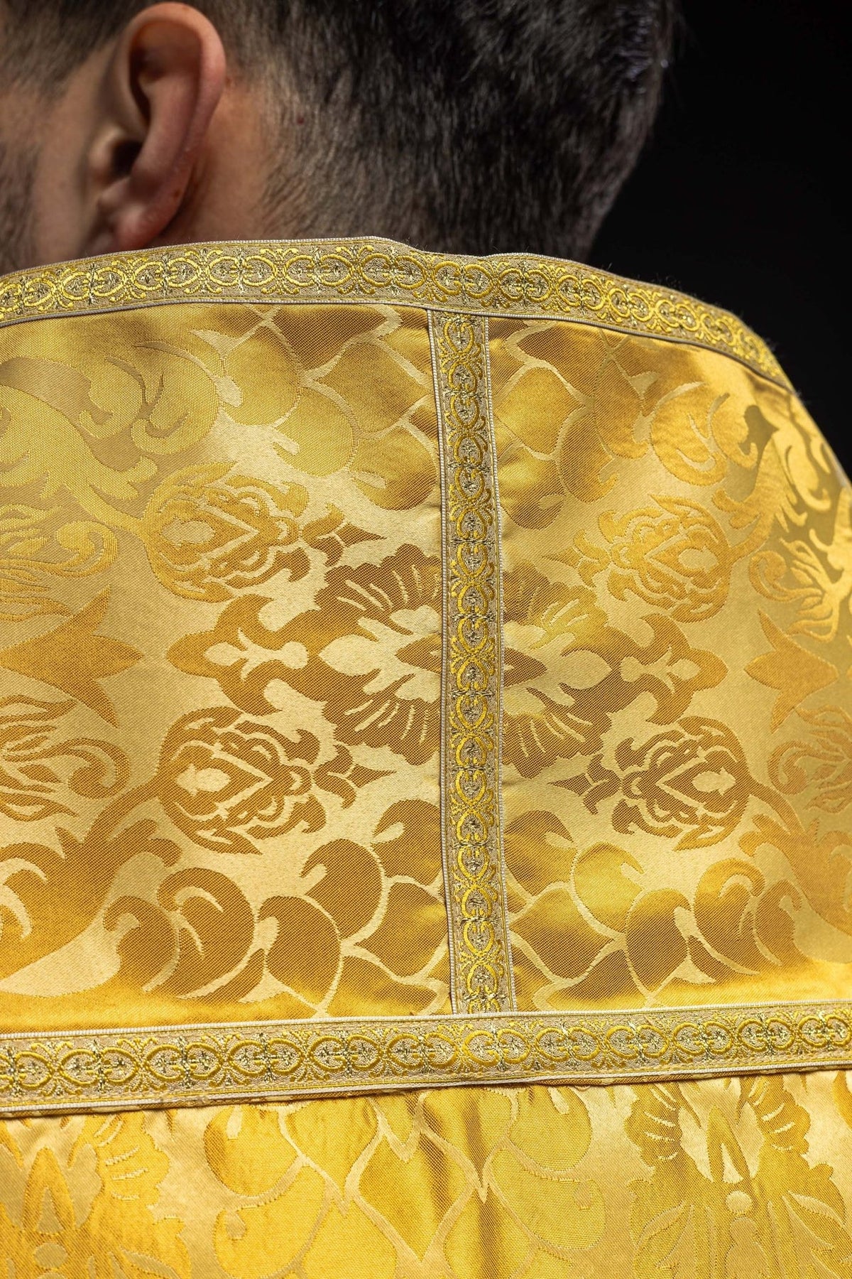Gold cope back close-up with floral jacquard fabric and gold trim