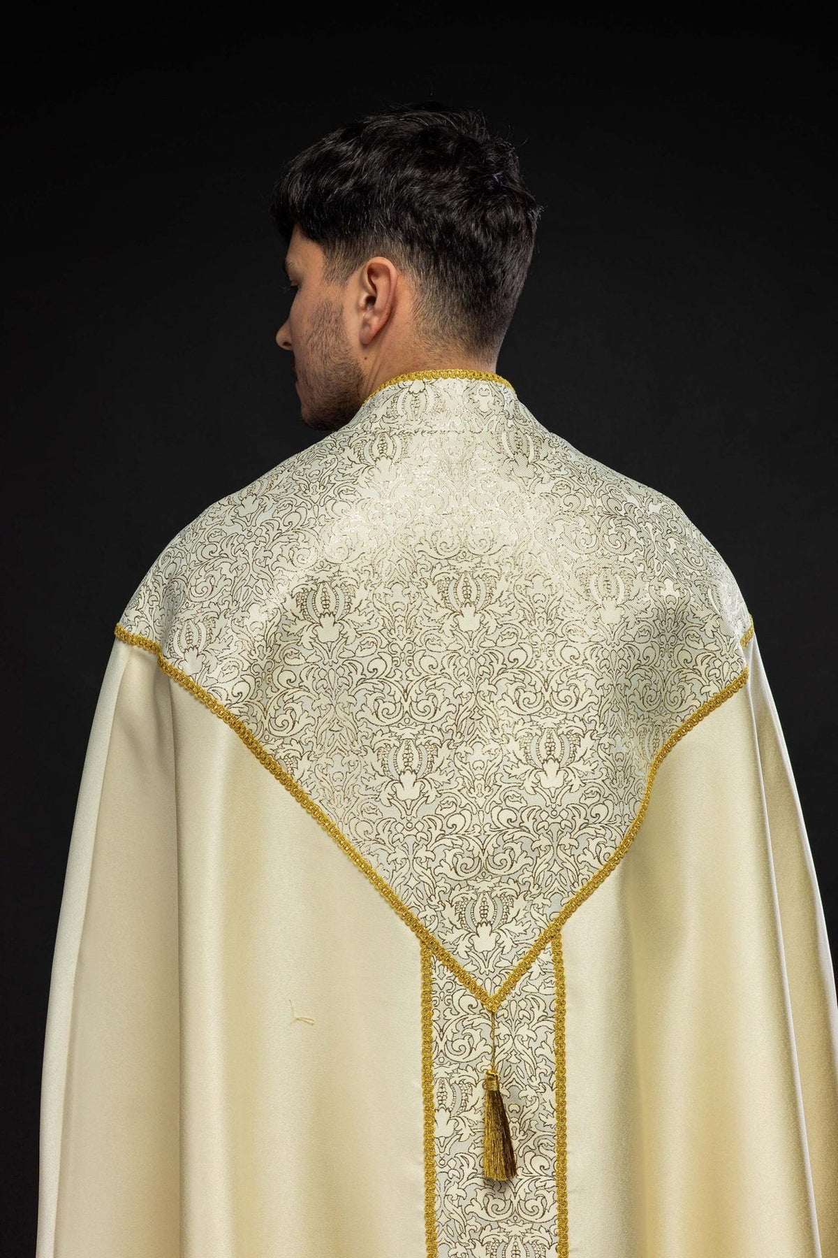Ecru cope back view with ornate jacquard fabric panels and gold edging