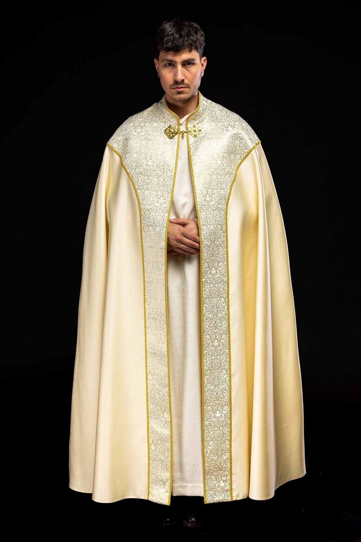 Ecru cope front view with ornate jacquard fabric panels and gold trim