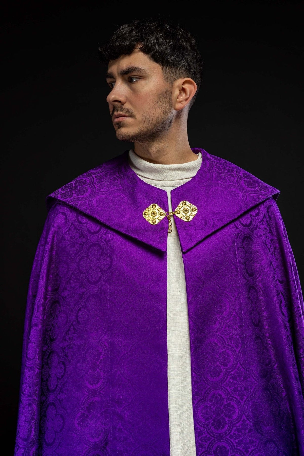 Purple cope close-up showing the front collar, gold clasps and jacquard pattern