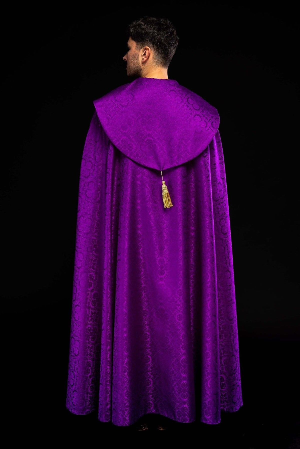 Purple cope shown from the back with its broad collar and gold tassel