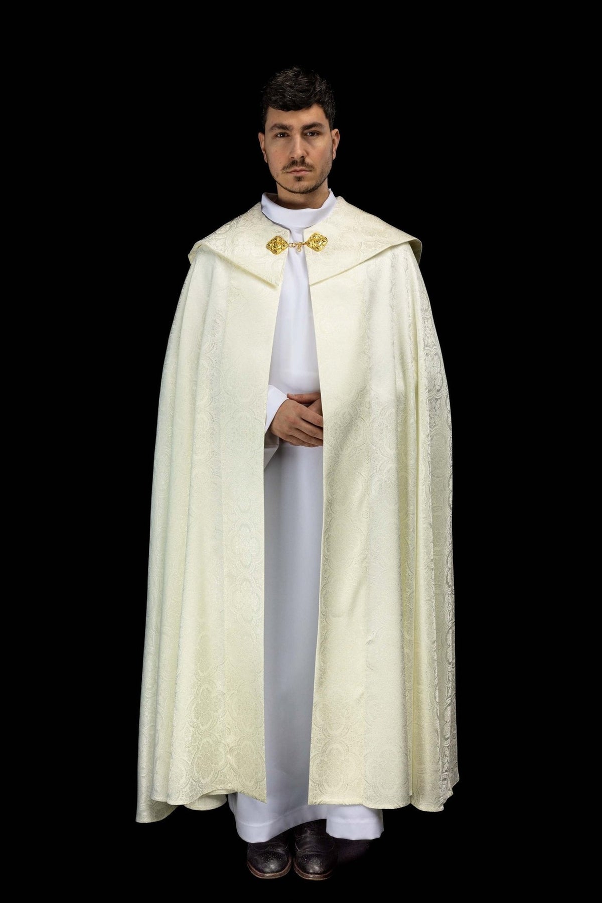 Ecru jacquard cope worn from the front with patterned fabric and gold clasp