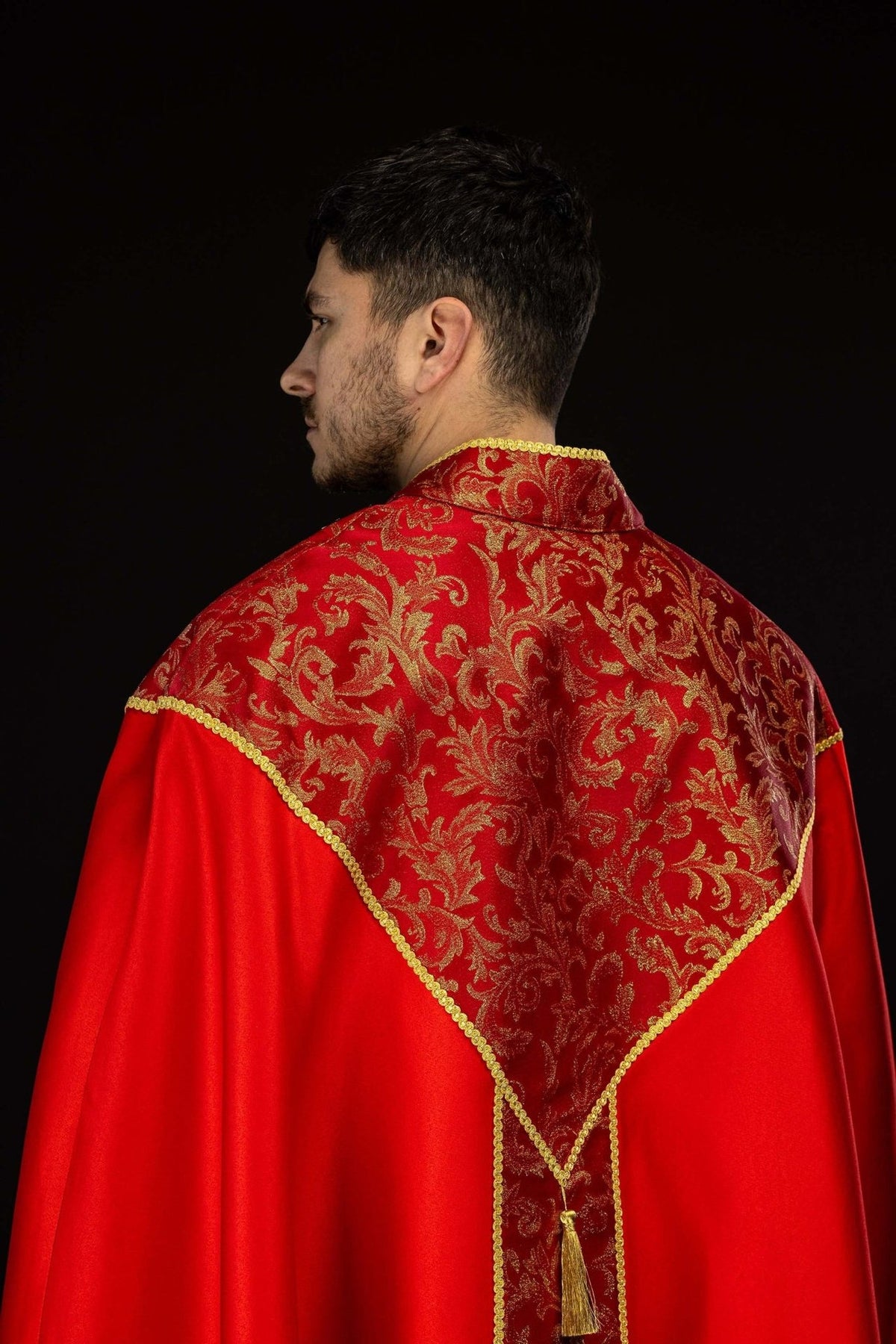 Red cope, close-up of front jacquard fabric panel with gold trim
