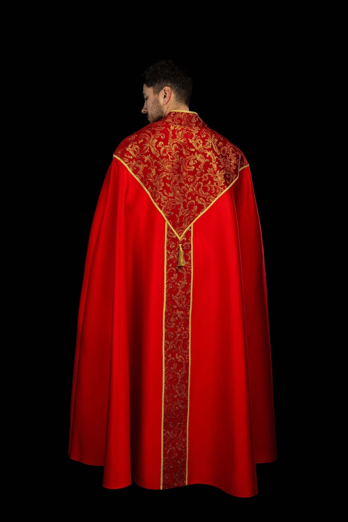 Red cope, close-up of back panel, gold trim and tassel