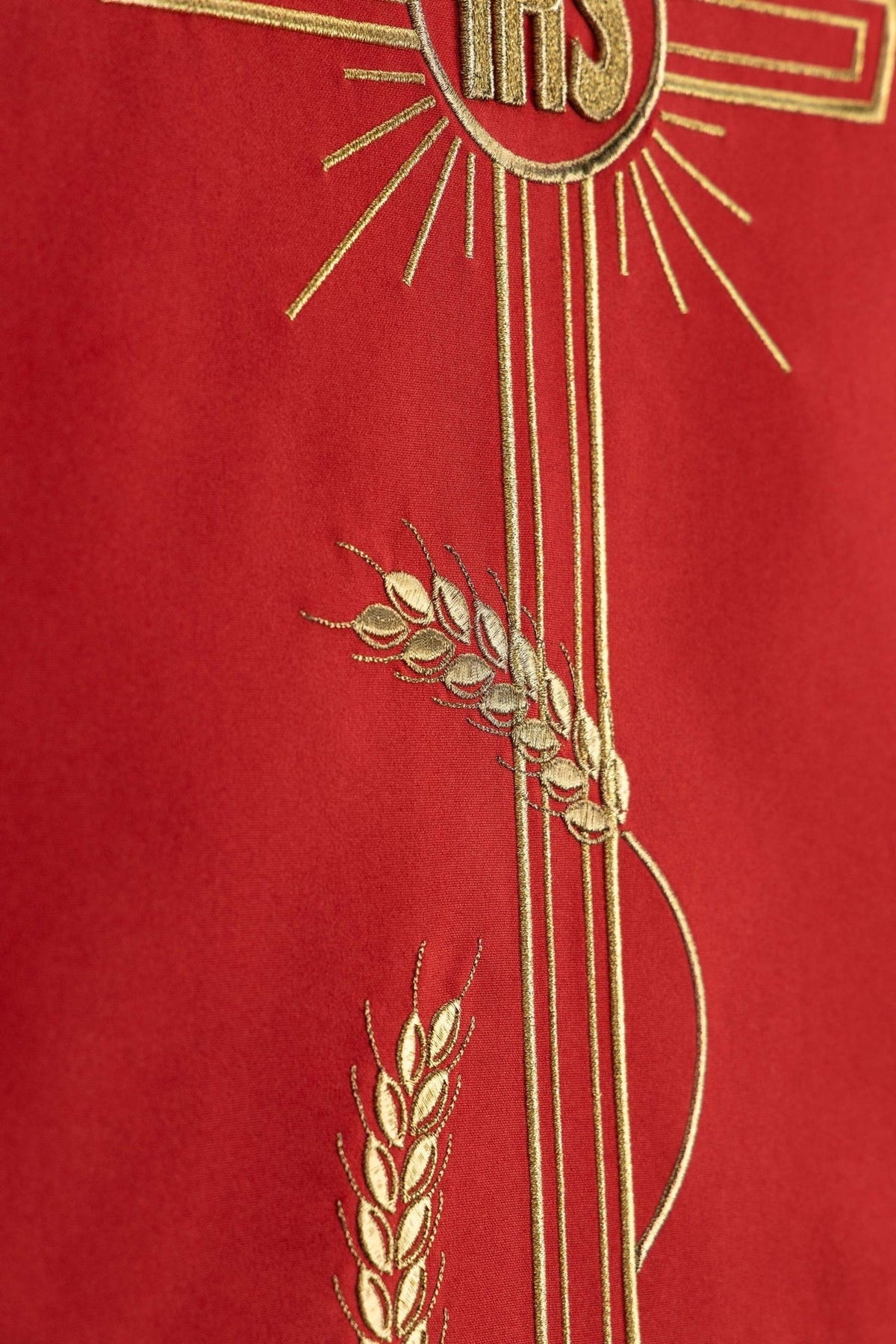 Red church lectern cover detail showing gold cross and wheat embroidery
