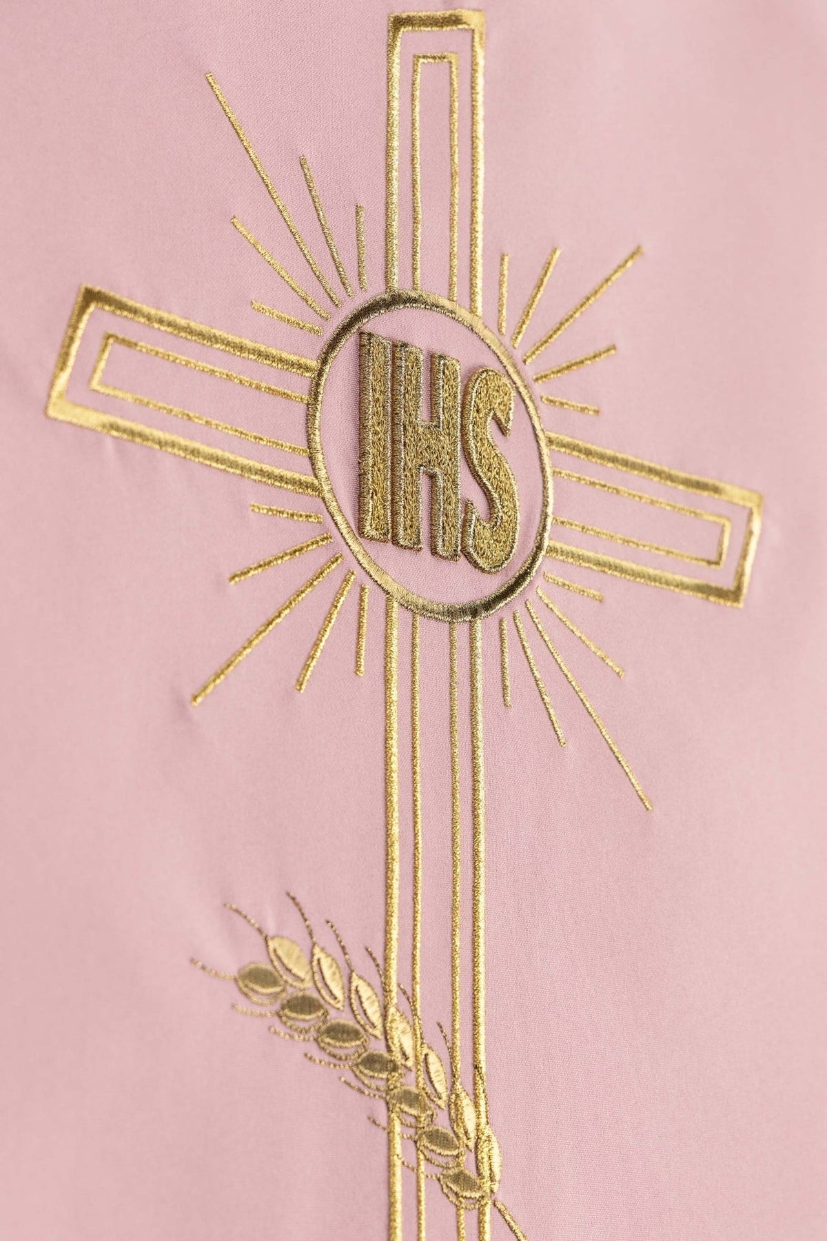 Embroidered church lectern cover detail with gold IHS monogram and cross