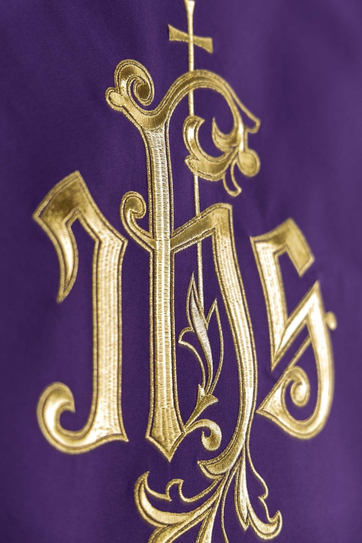 Purple church lectern cover detail of the gold embroidered IHS monogram