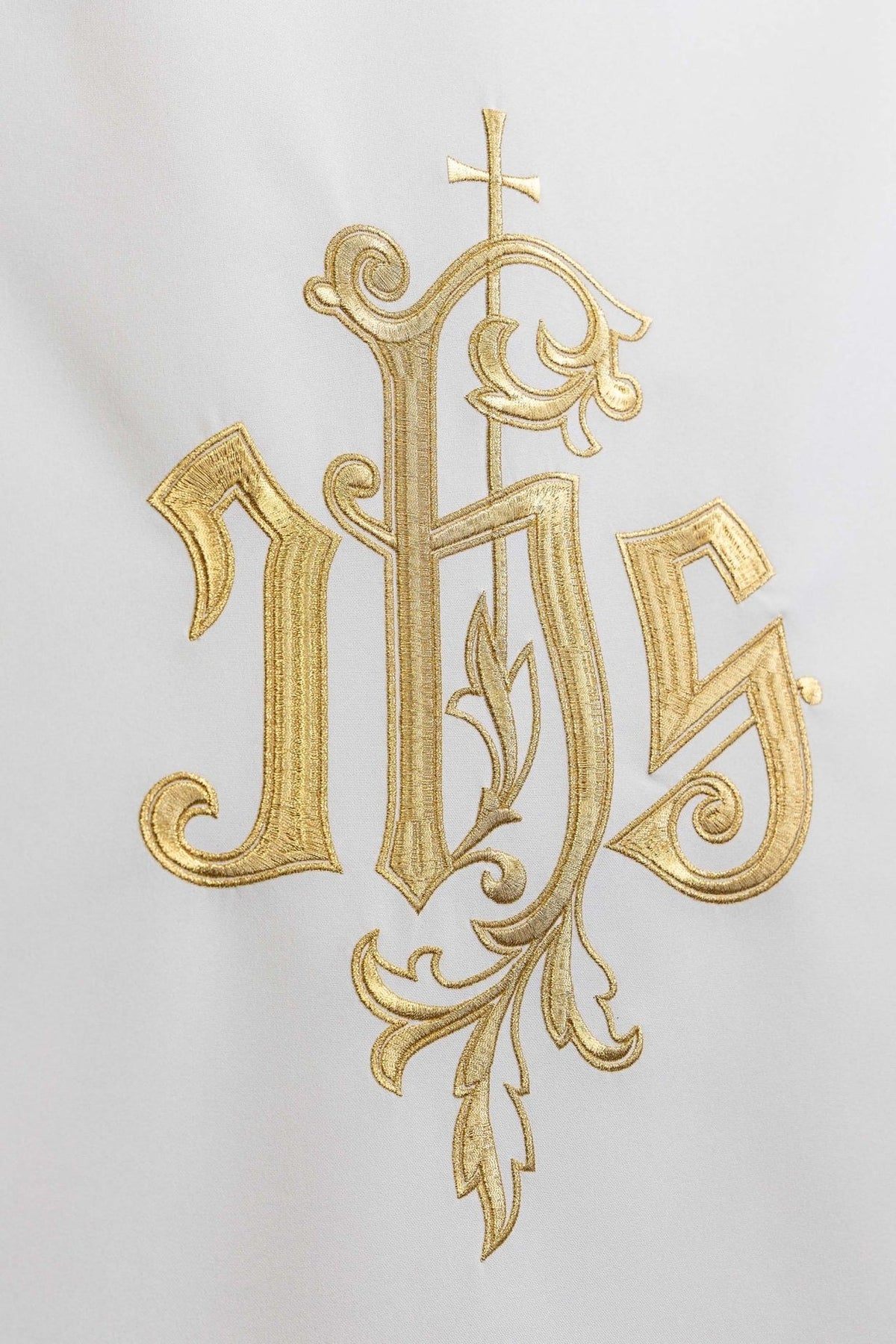 Church lectern cover close-up showing gold embroidered IHS symbol