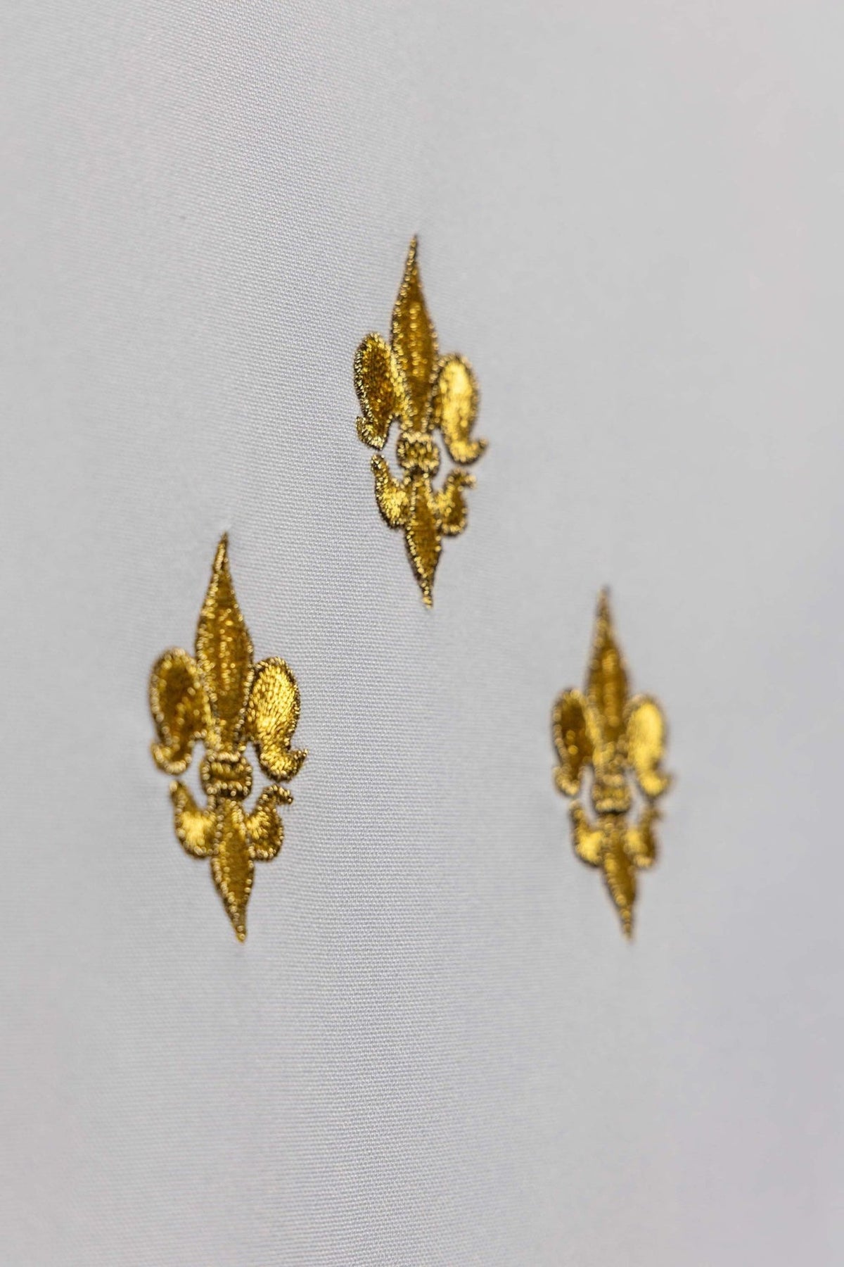 Church lectern cover close-up of gold embroidered fleur-de-lis motifs