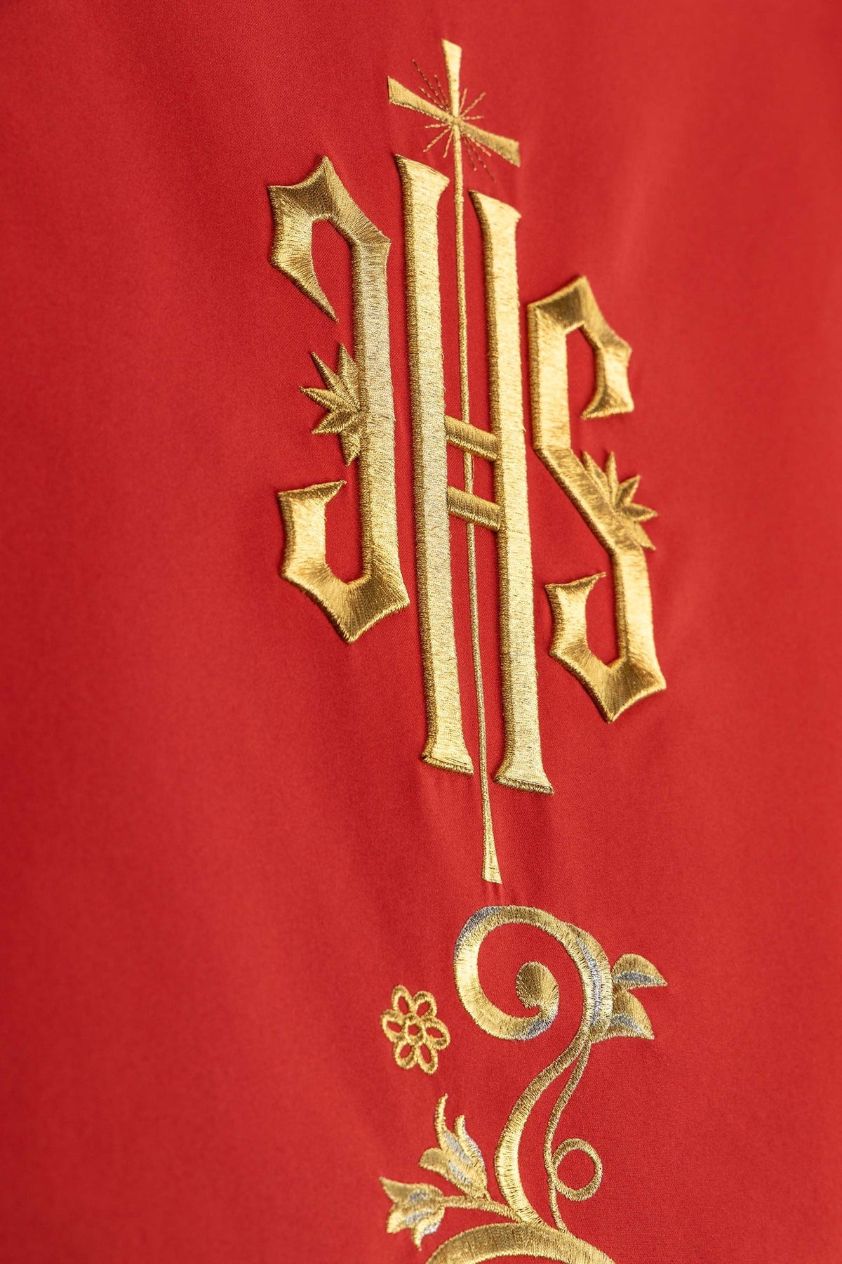 Church lectern cover detail showing the gold IHS monogram and botanical embroidery