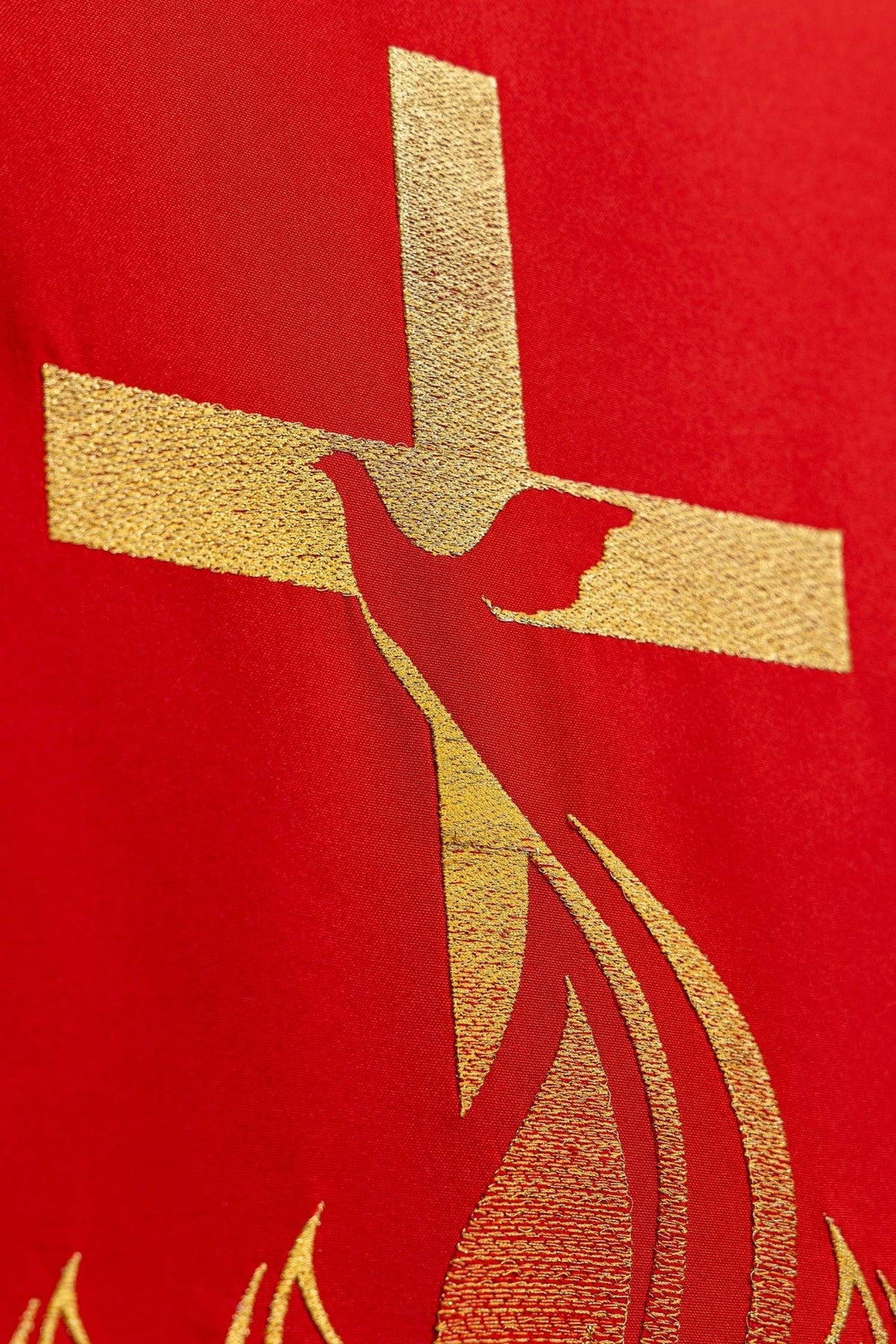 Embroidered red church lectern cover close-up of the gold Holy Spirit dove and cross