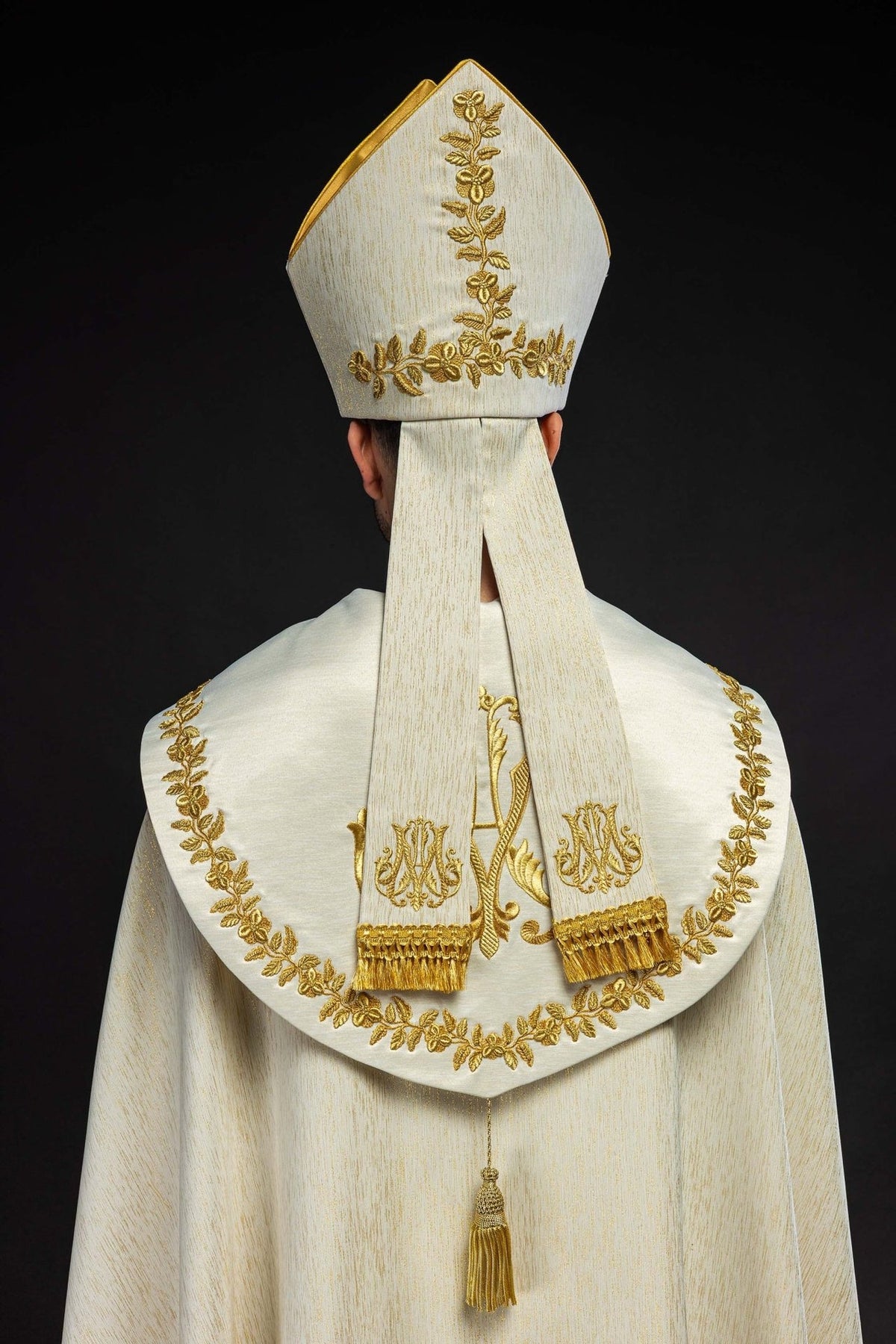 Ecru miter, back view with gold floral embroidery and long fabric bands