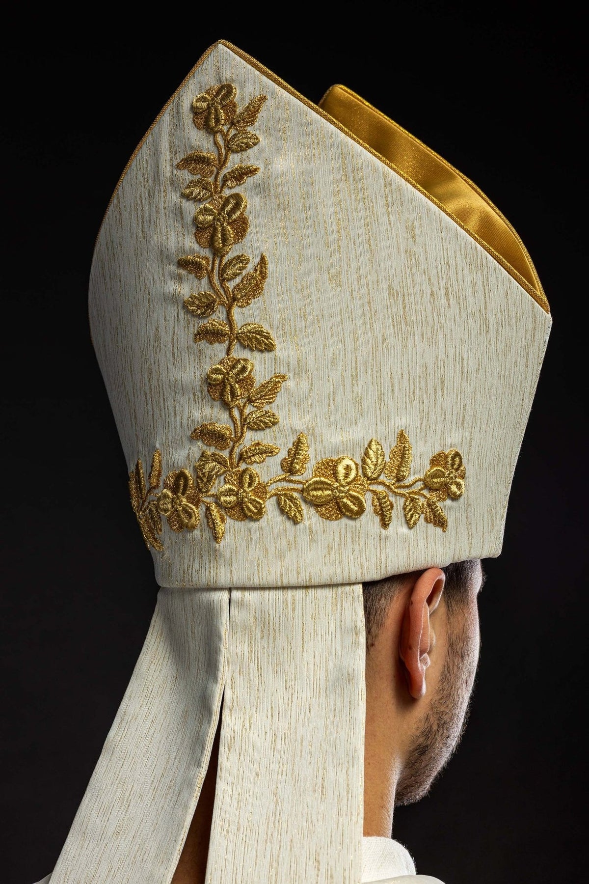 Ecru miter, side view with gold floral embroidery and gold-edged top