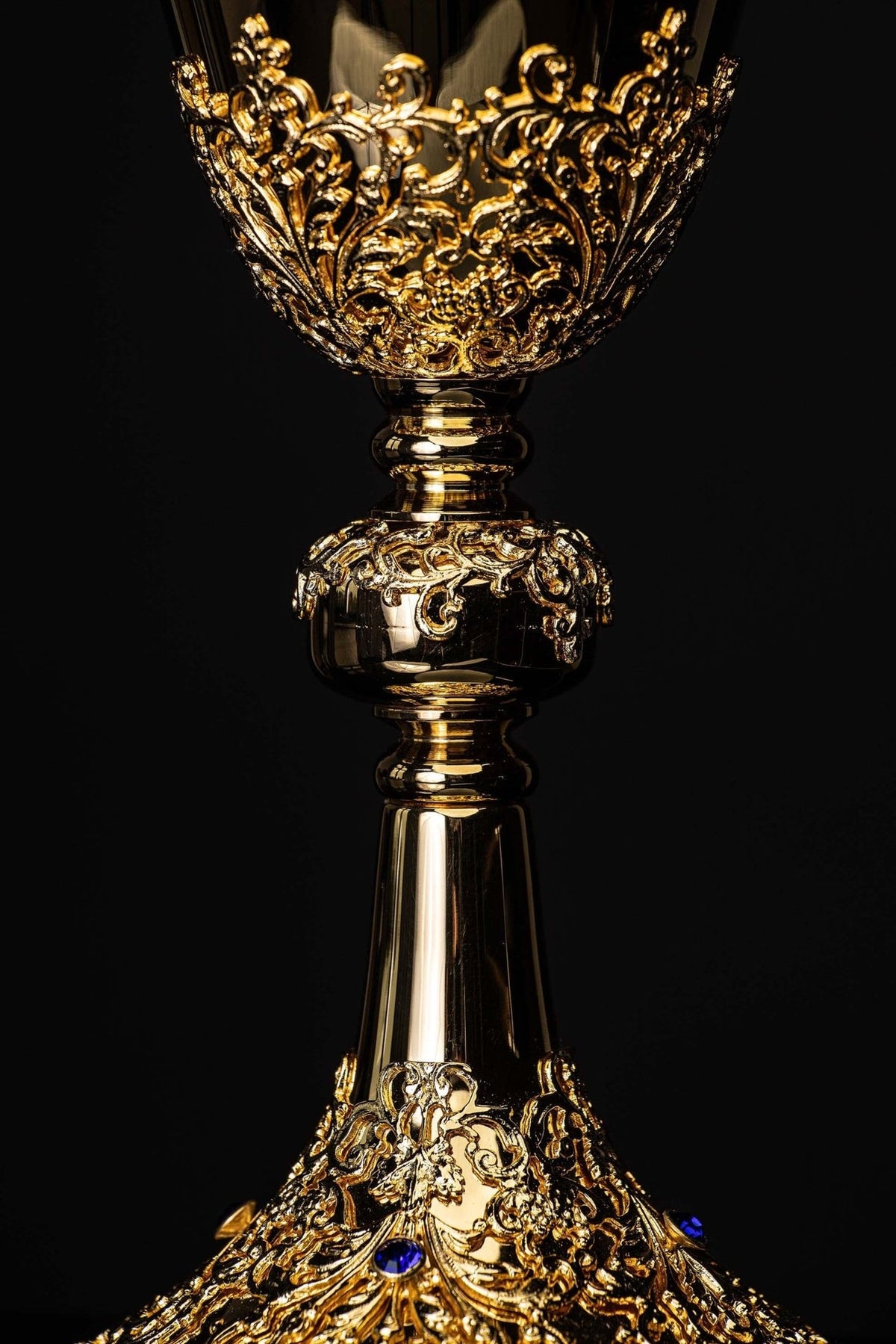 Gold-plated chalice close-up of botanical ornaments on the cup and stem