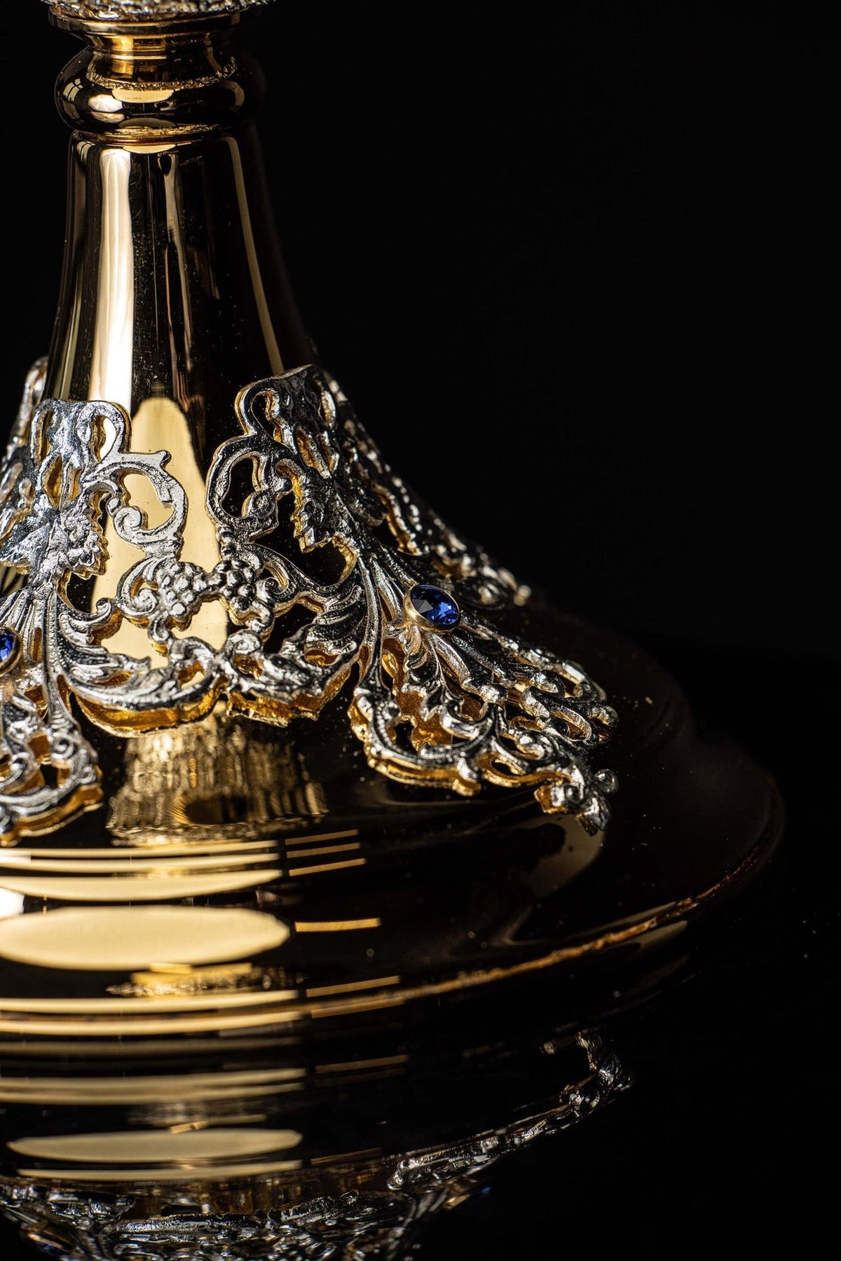 Chalice close-up showing intricately decorated silver-toned central node