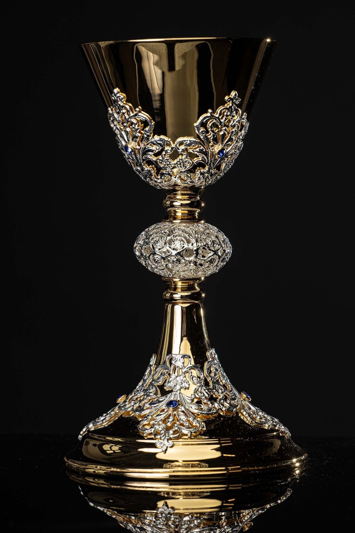 Gold-plated chalice full front view with ornate floral scrollwork and imitation sapphires