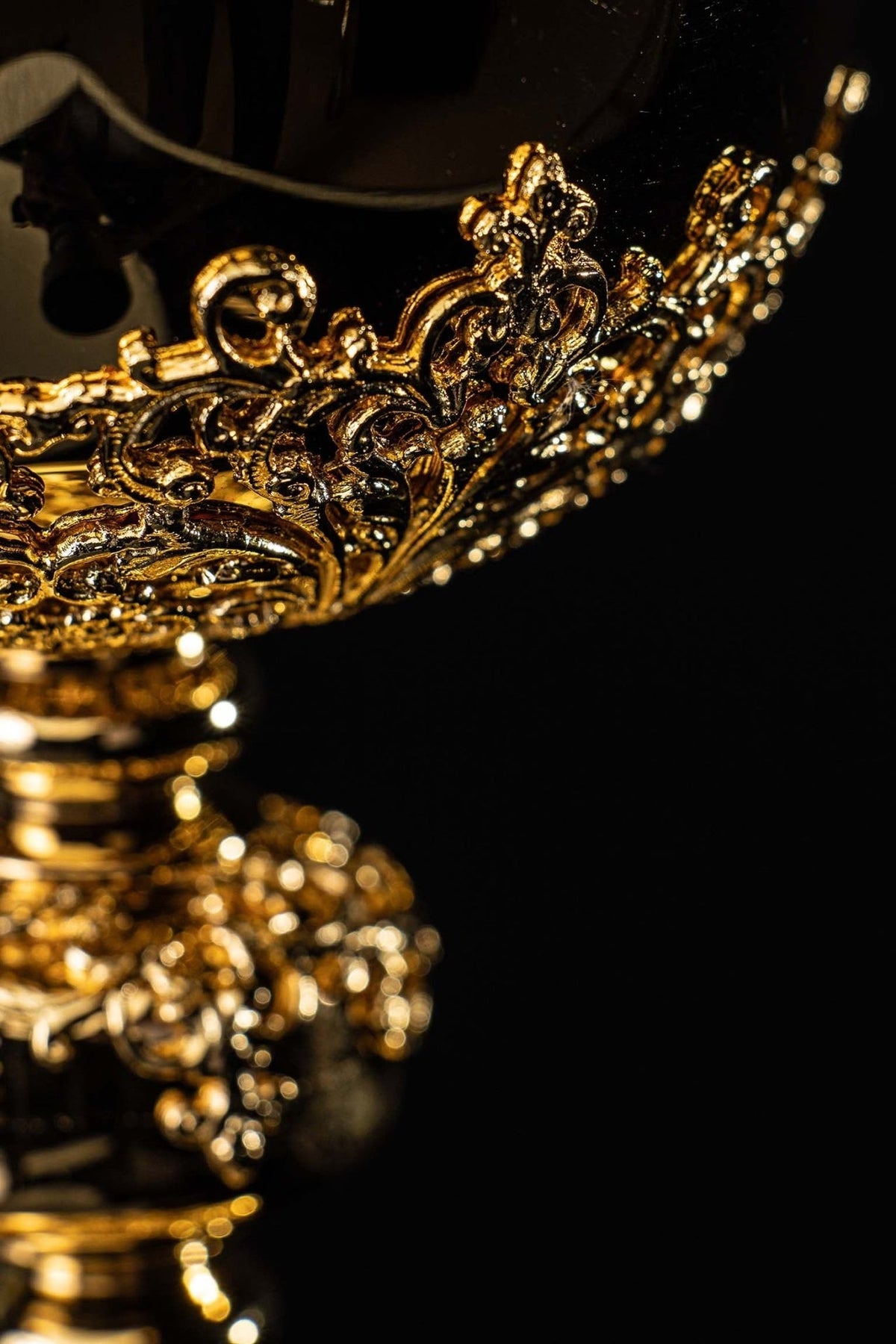 Gold-plated ciborium close-up of raised scrollwork on the bowl and decorated stem