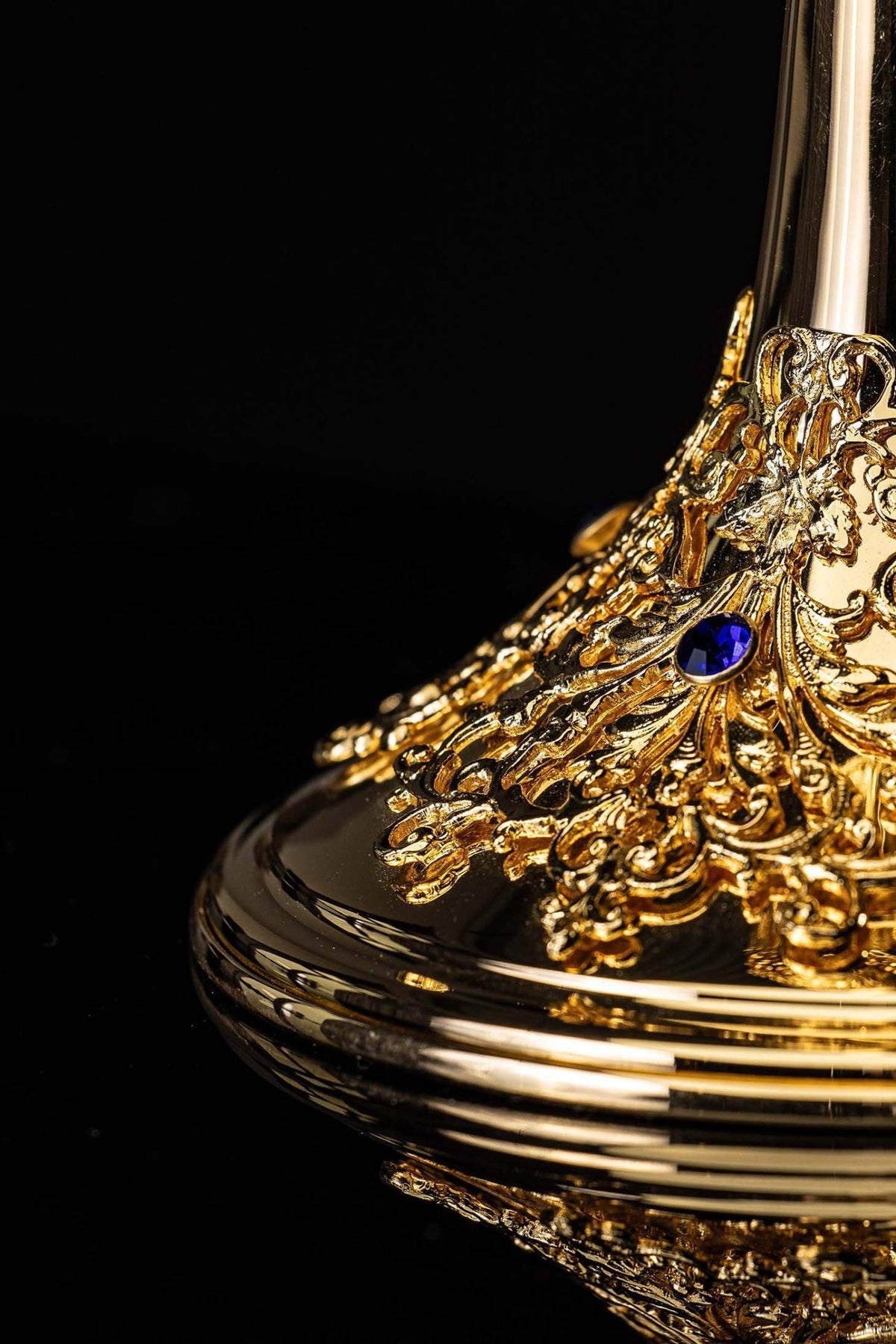 Gold-plated ciborium base detail showing a blue sapphire among ornate gold scrollwork