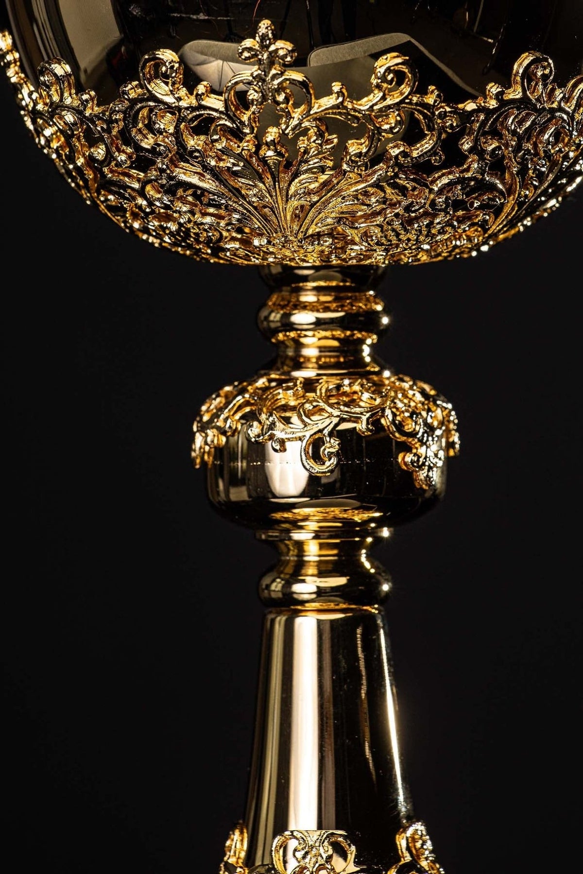 Gold-plated ciborium close-up of ornate bowl decoration and polished stem