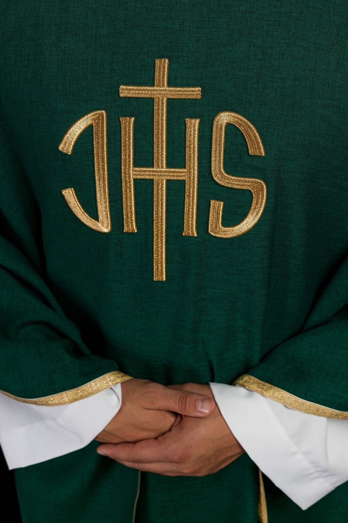 Green chasuble close-up showing gold IHS embroidery and trim
