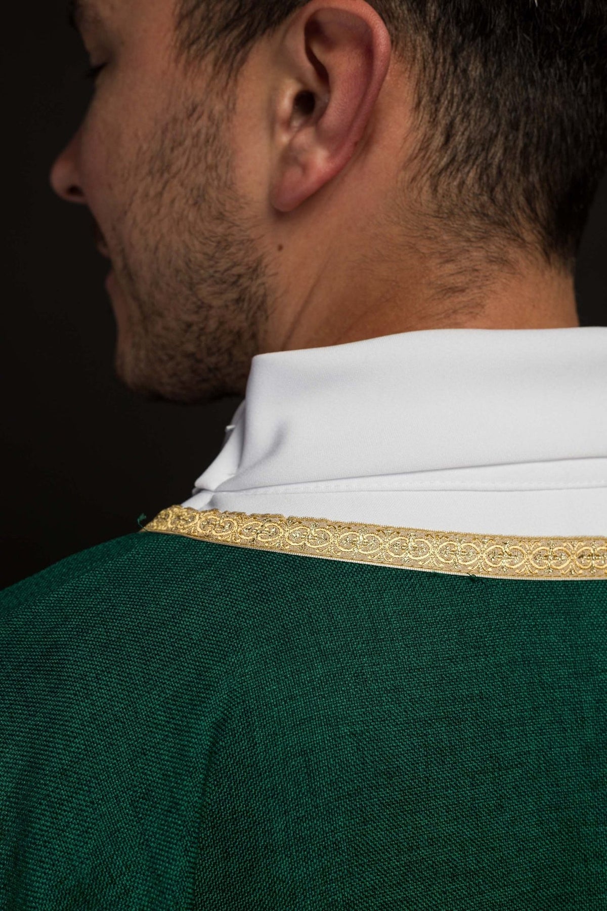 Green chasuble detail showing gold trim around the neckline