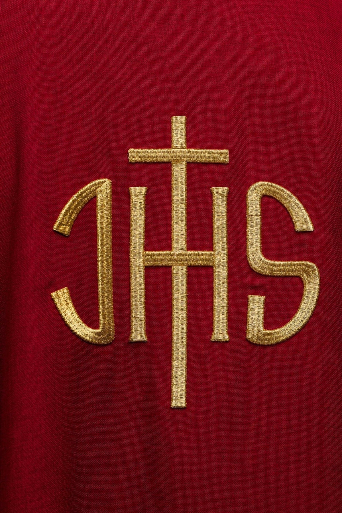 Red chasuble close-up showing gold neckline trim