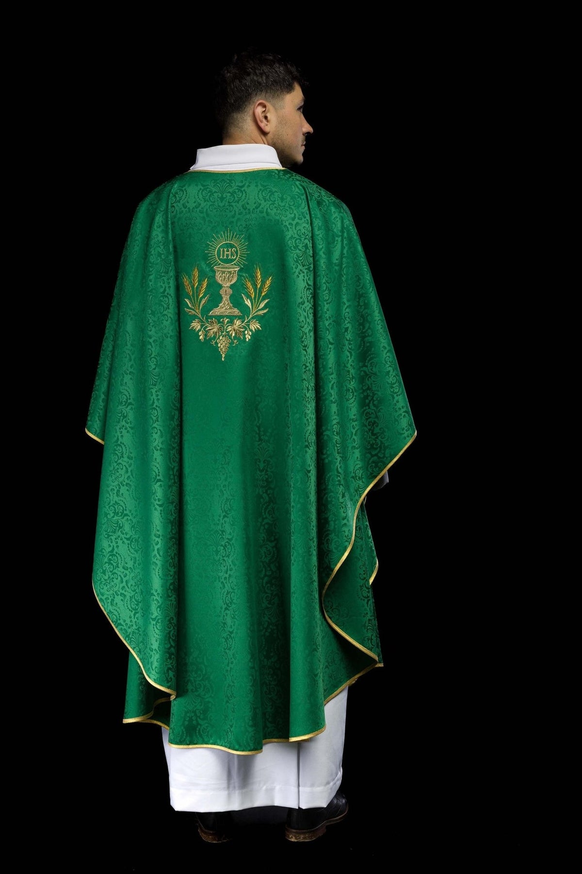 Green chasuble back view with gold-trimmed edges and chalice embroidery