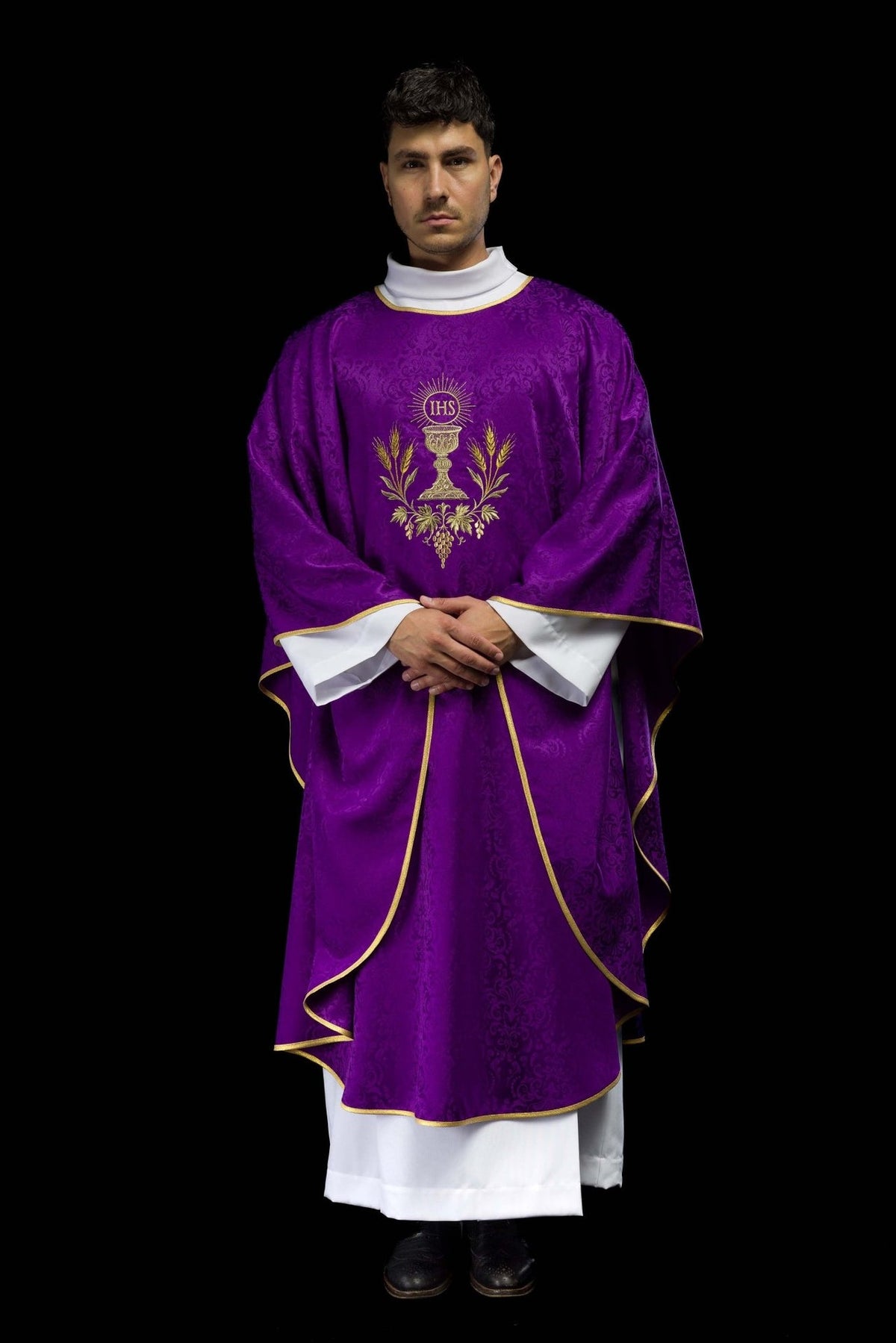 Purple chasuble worn in front view with gold chalice, IHS monogram and wheat embroidery
