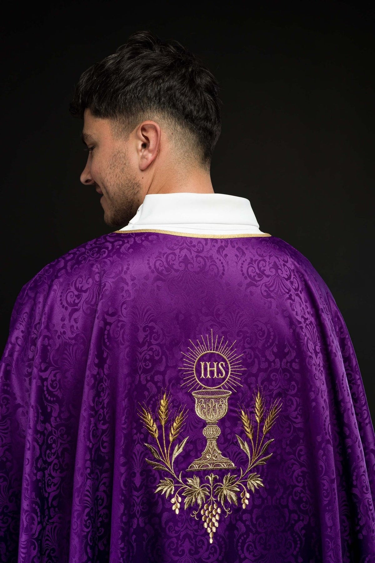 Purple chasuble back view with gold chalice, IHS monogram and vine embroidery