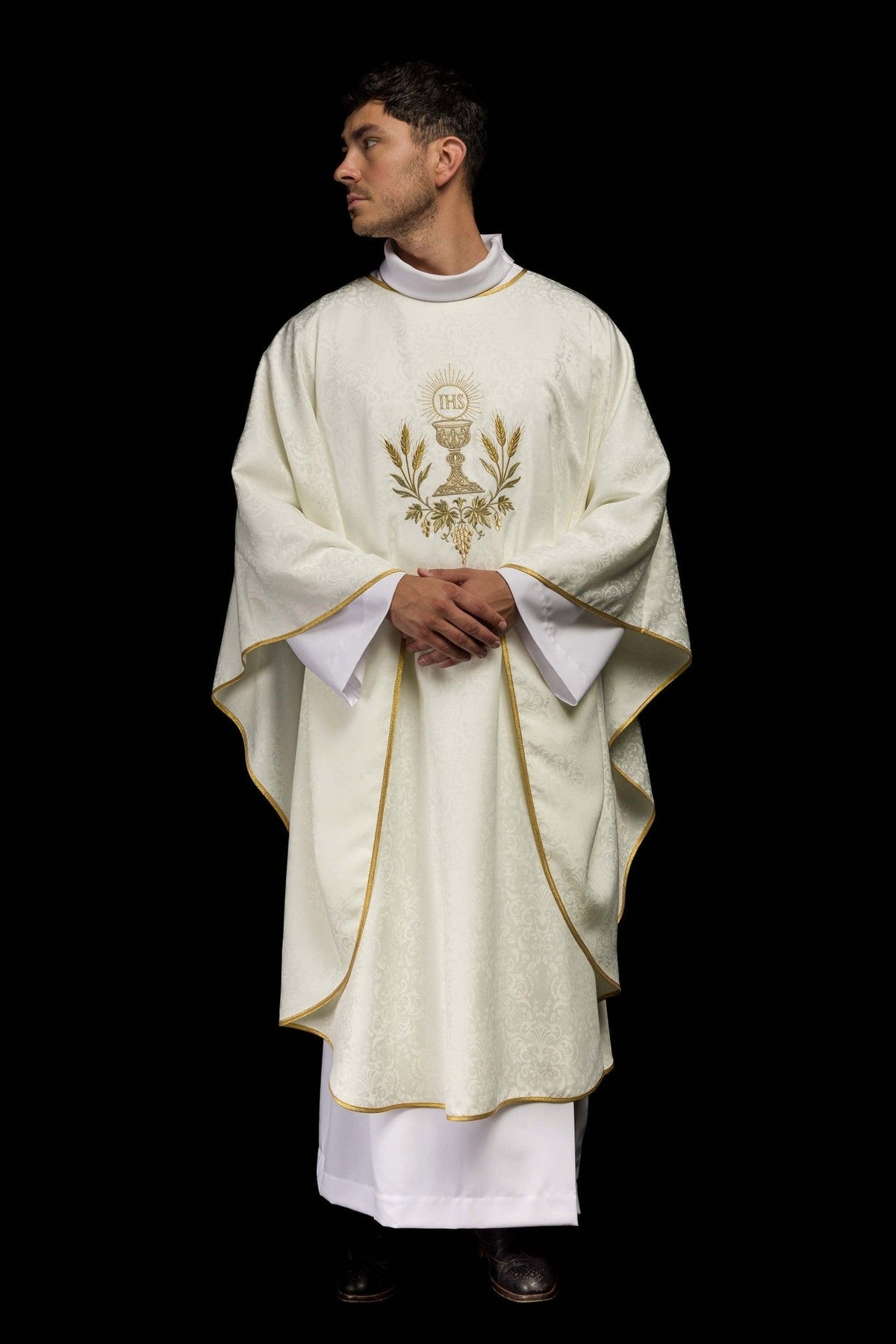 Ecru chasuble worn front view with gold Eucharistic embroidery and scalloped trim