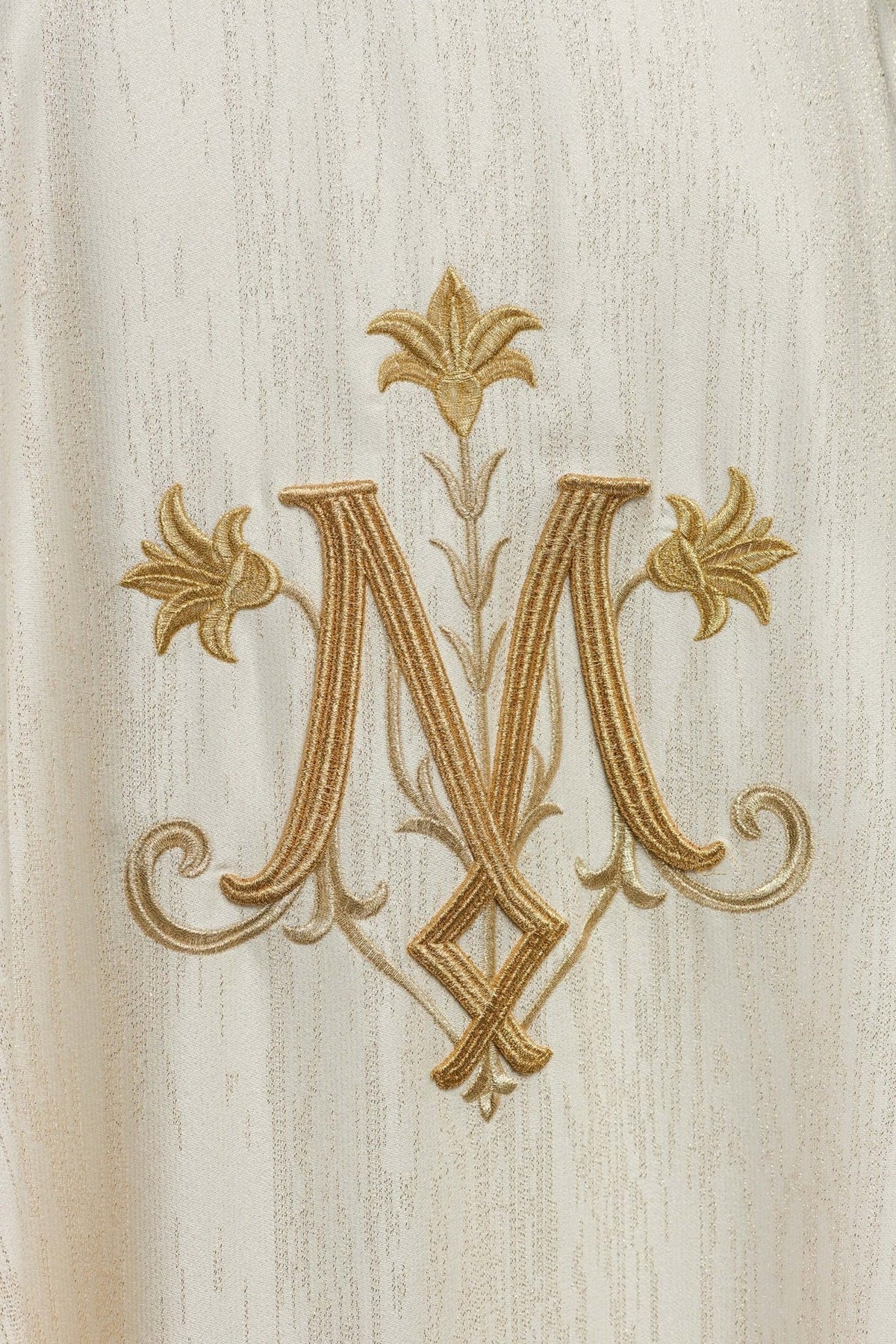 Ecru Marian motif chasuble, close-up of gold embroidered motif