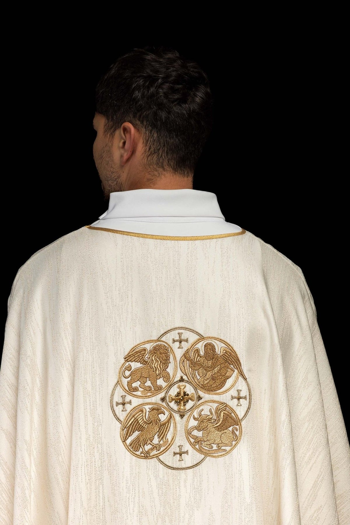 Ecru chasuble back view with gold trim and fabric texture