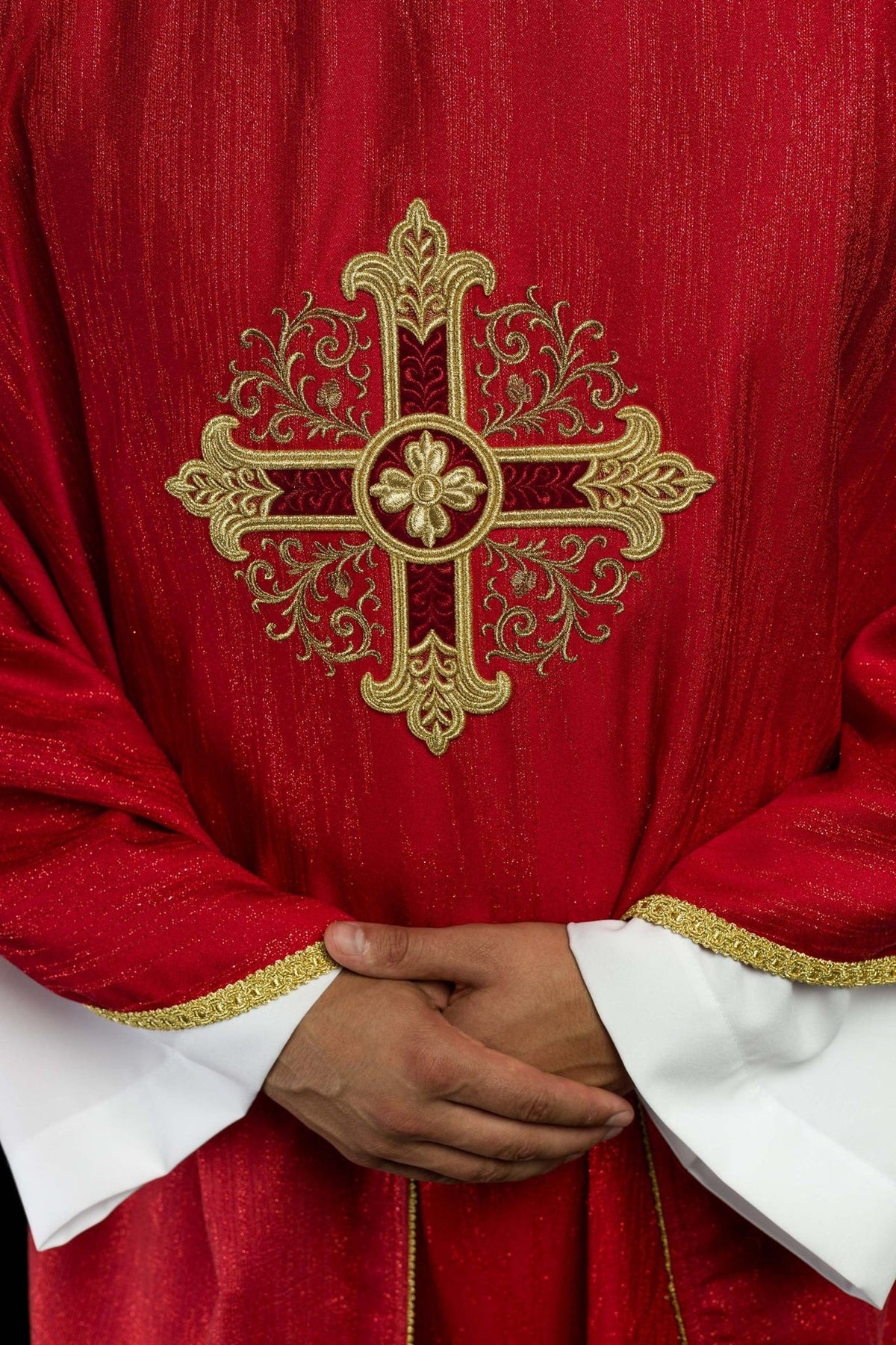 Red chasuble front detail showing gold cross embroidery and trim