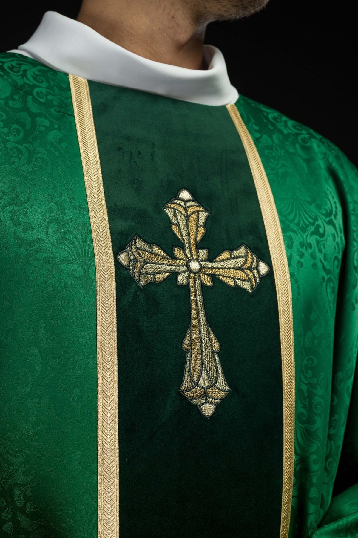Green chasuble front close-up with gold cross embroidery and trim