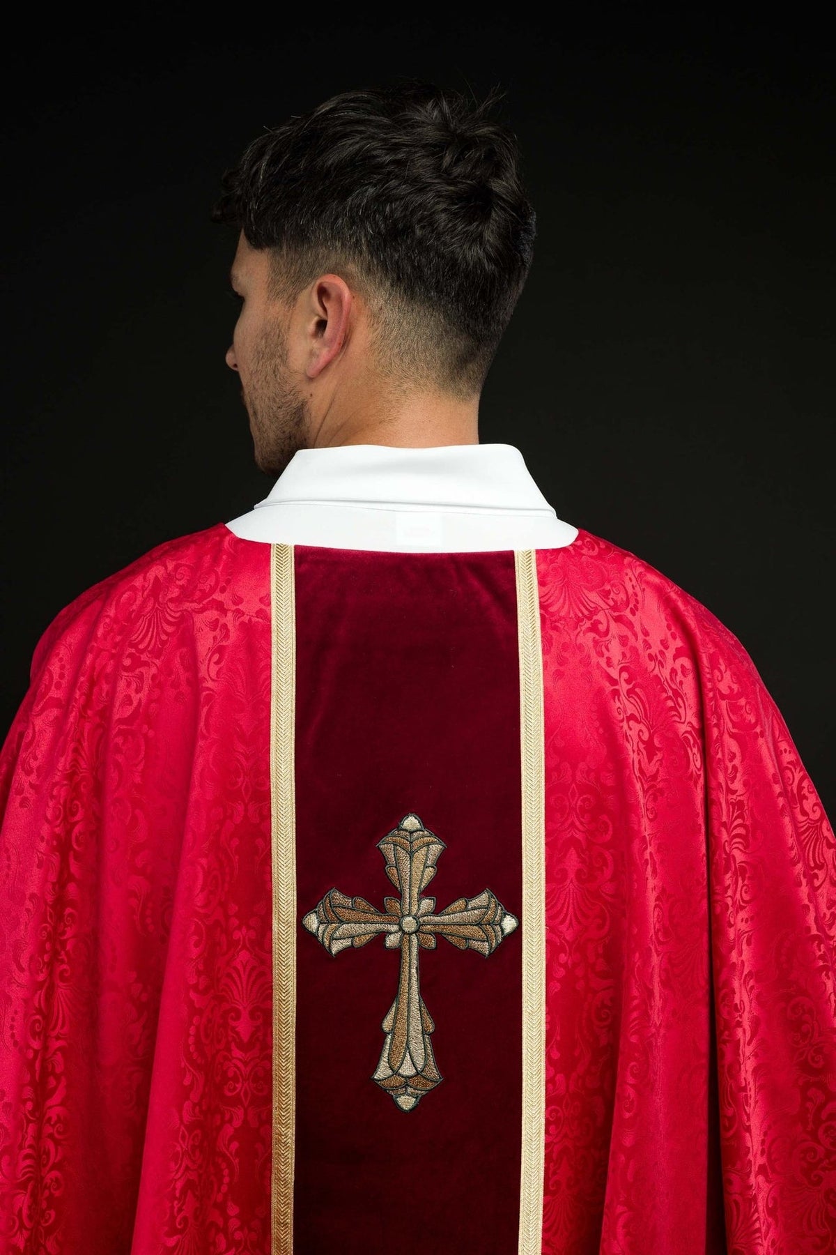 Red chasuble back view with gold orphrey and cross embroidery