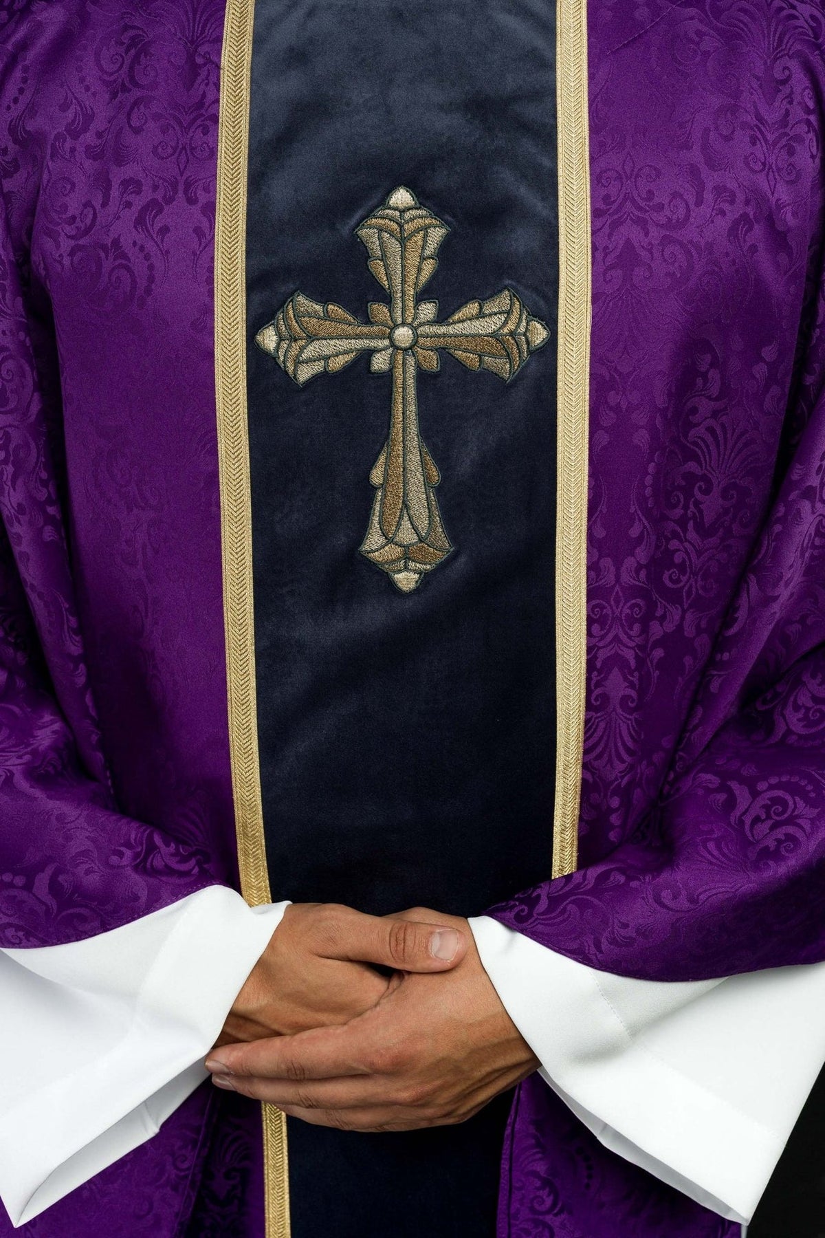 Purple chasuble, close-up of gold cross embroidery on the front orphrey