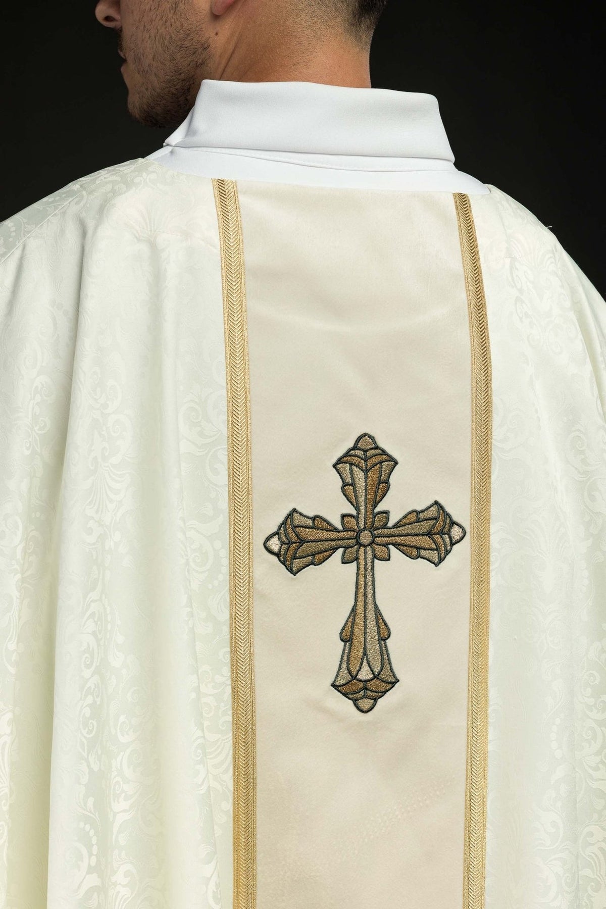 Ecru chasuble back close-up with embroidered cross and gold orphrey