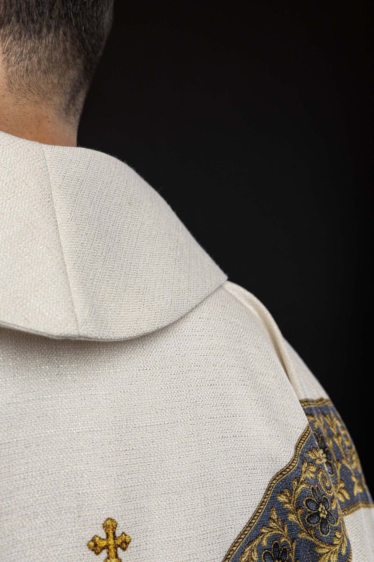 Marian chasuble close-up showing blue floral orphrey, gold embroidery and ecru fabric