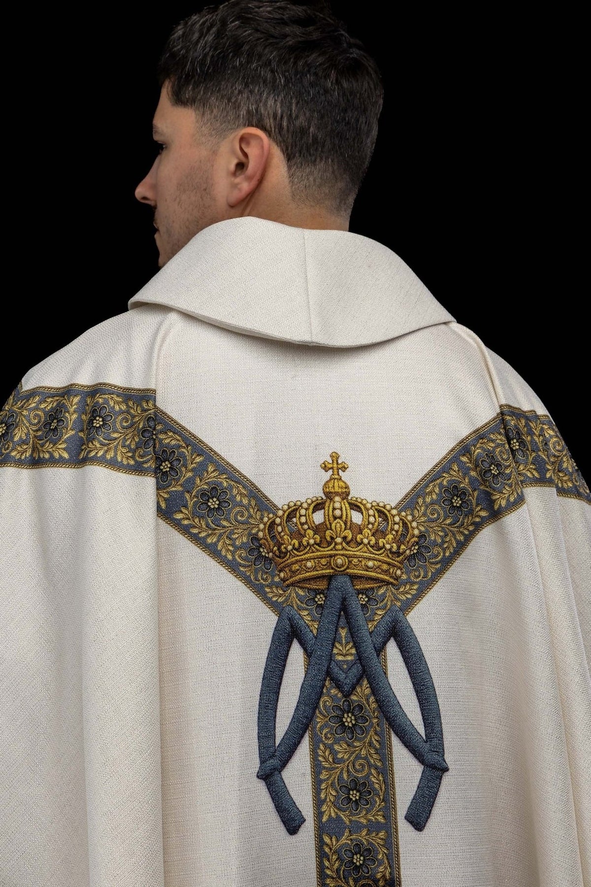 Marian chasuble back close-up showing blue floral trim and crown with Marian symbol