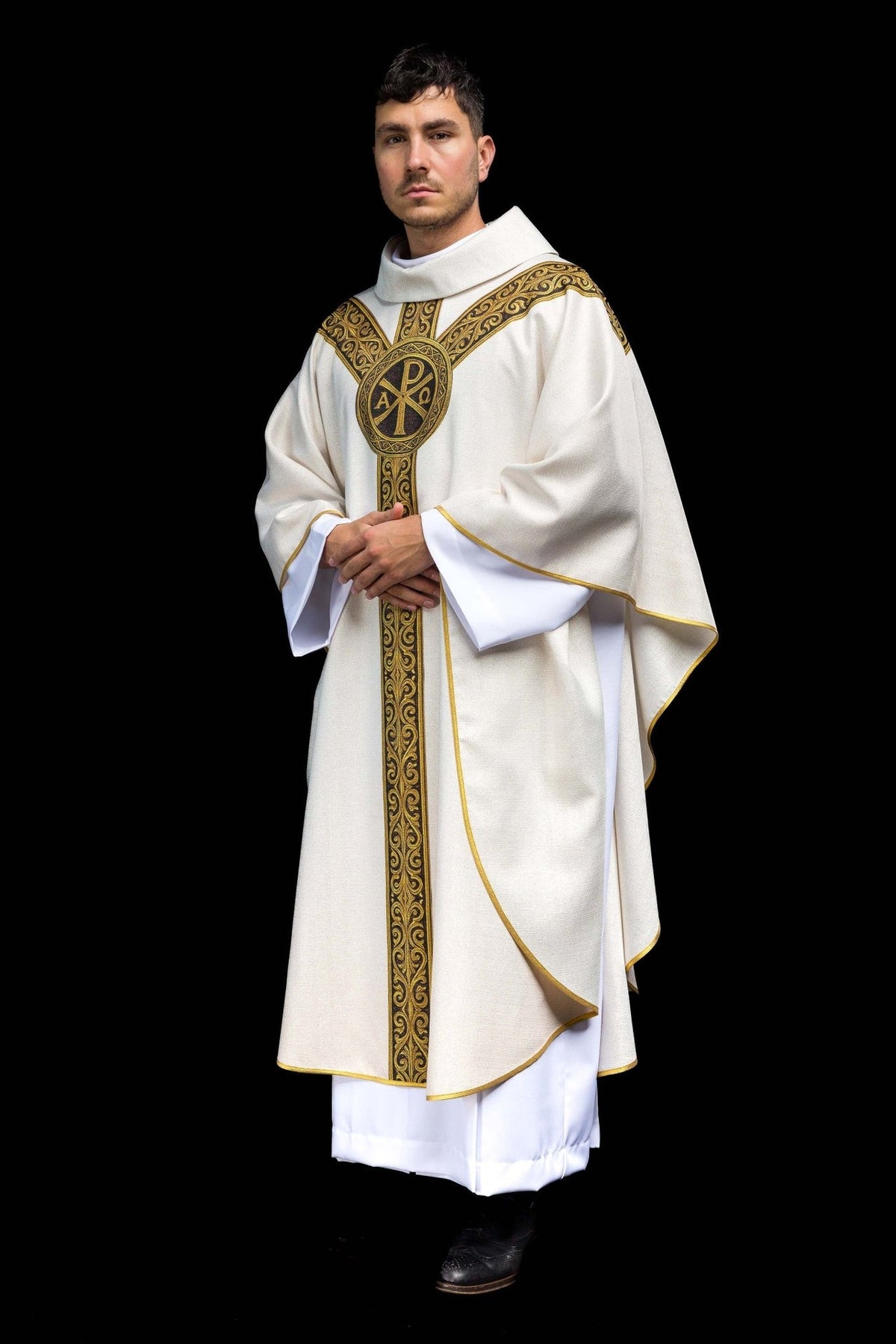 Ecru Catholic chasuble side view showing flowing cream fabric and gold trim