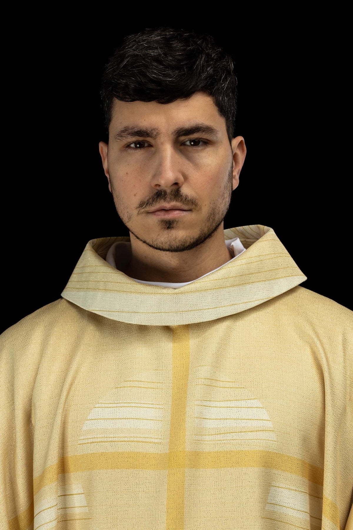 Ecru chasuble close-up showing the cross motif and collar