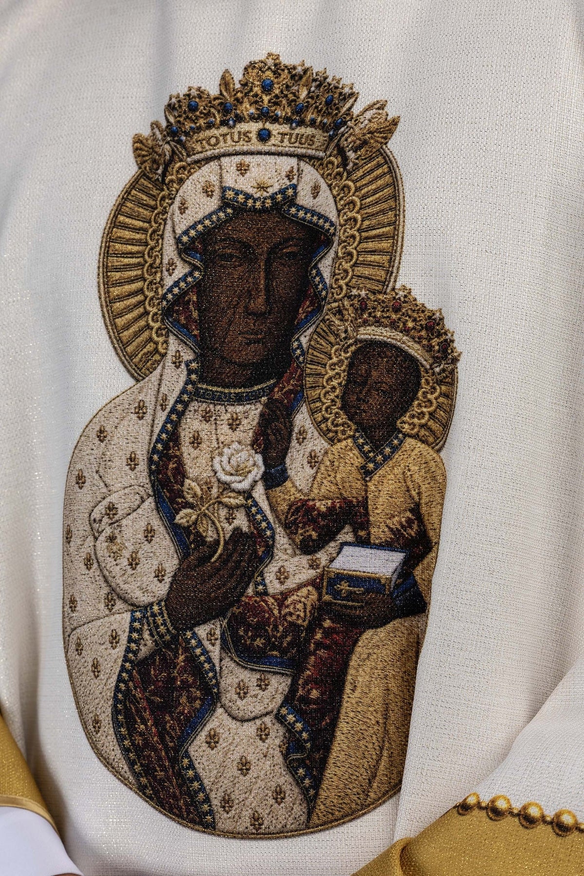 Printed chasuble close-up showing embroidered Our Lady and Child image