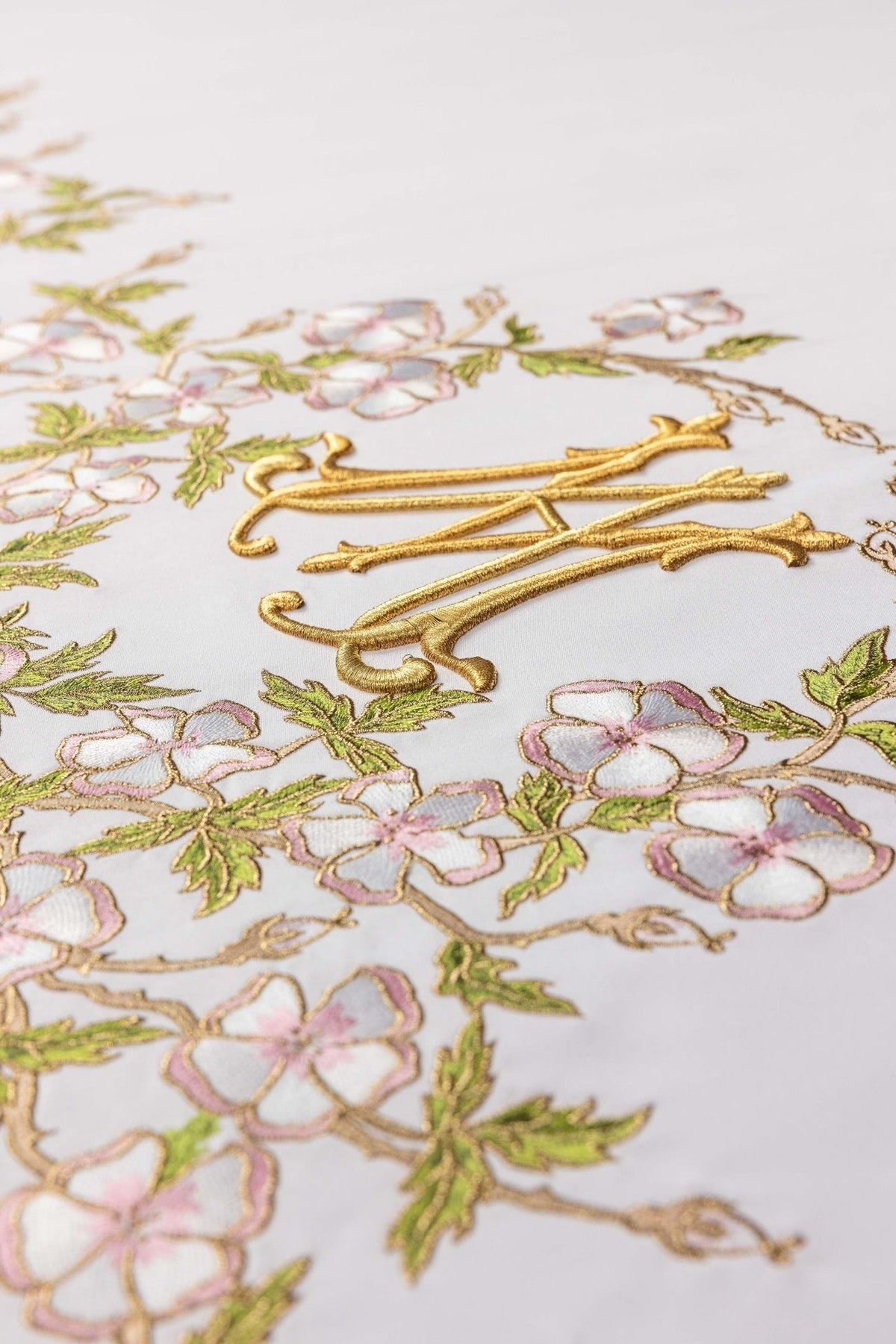 Altar cloth close-up showing raised gold embroidery and pink floral border