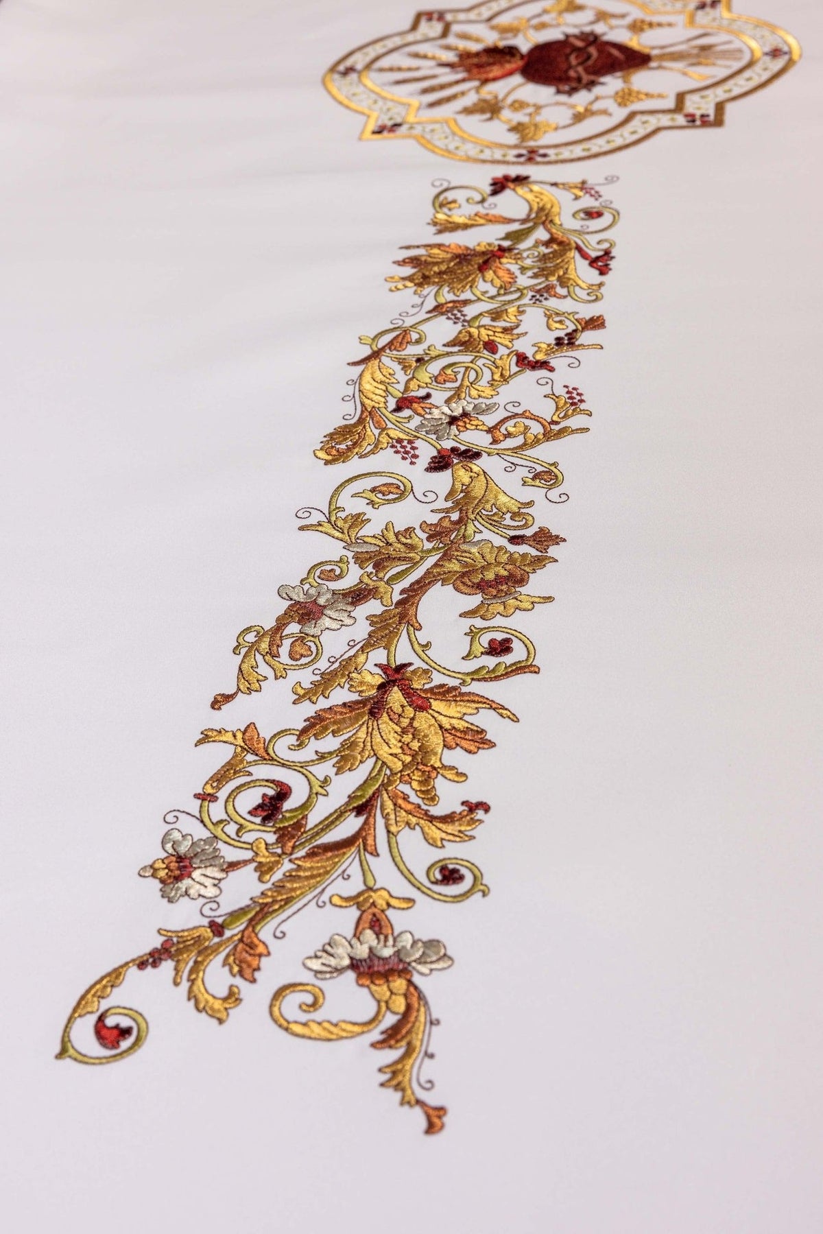 Sacred Heart of Jesus altar cloth detail showing floral gold embroidery on white fabric