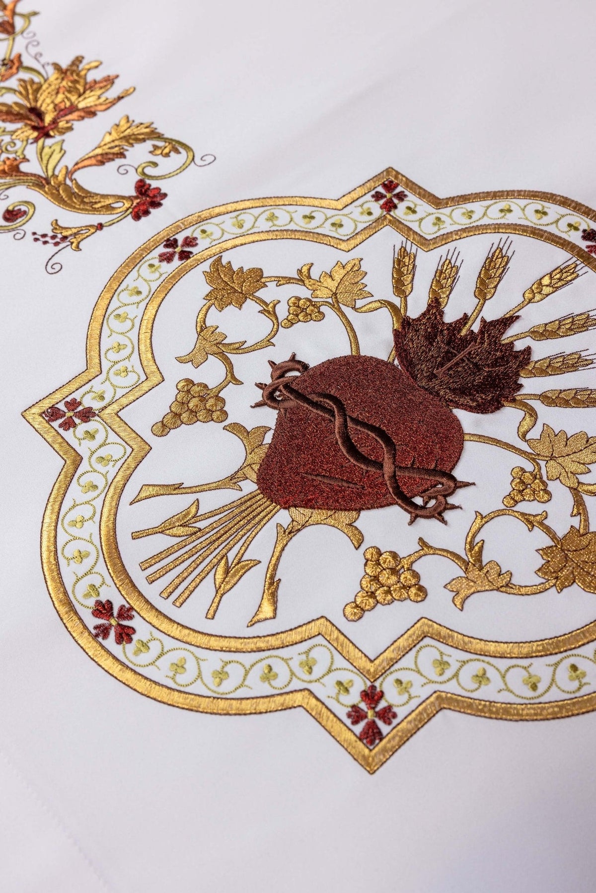 Sacred Heart of Jesus altar cloth close-up showing heart and ornate gold embroidered border