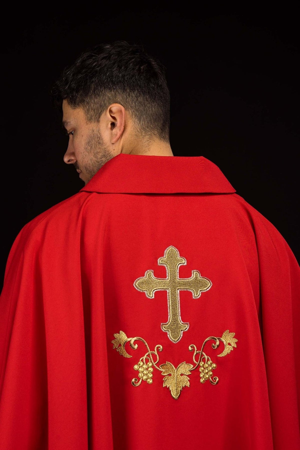 Red chasuble back view with gold cross and grape embroidery