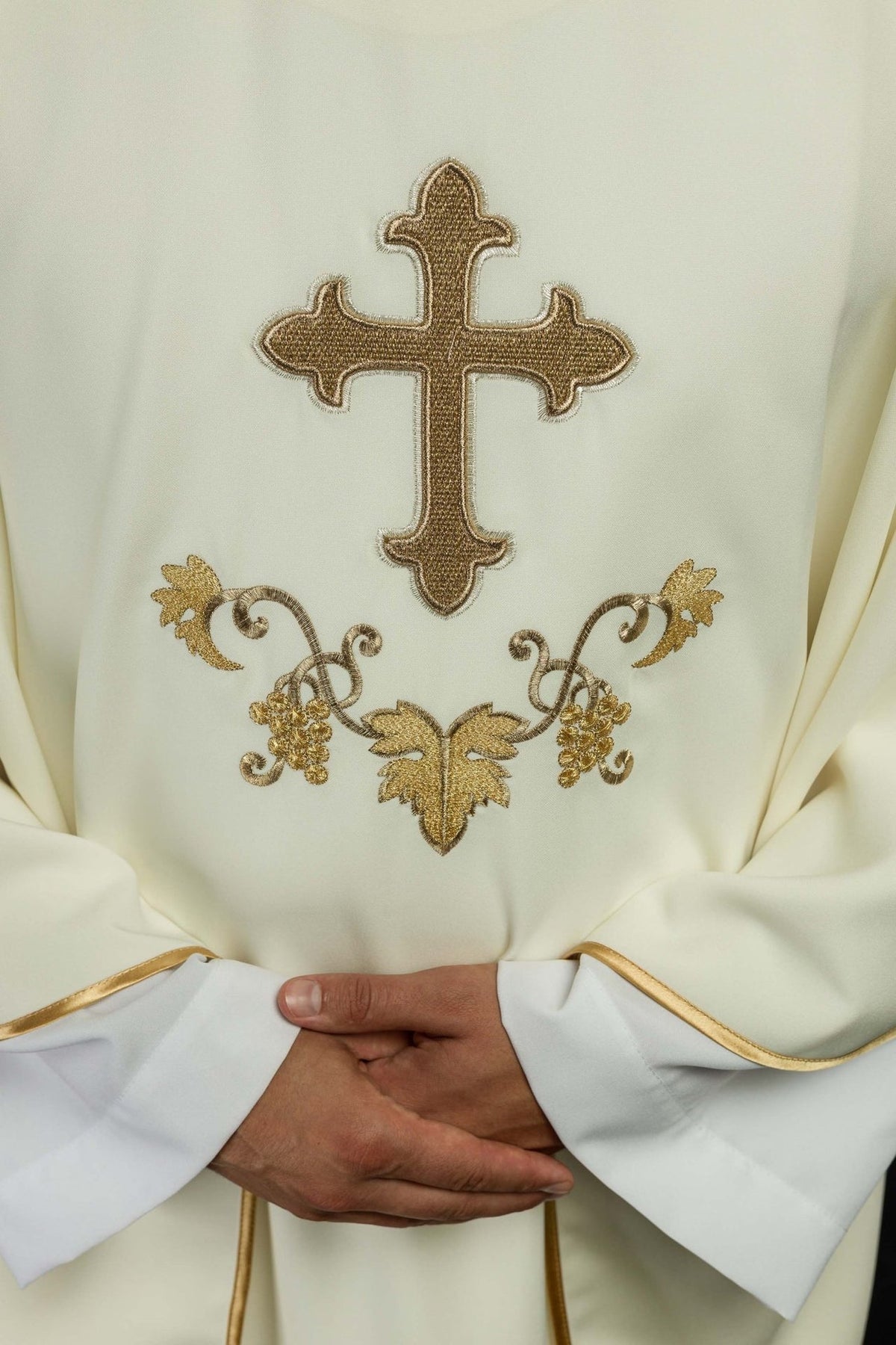 Embroidered chasuble close-up showing gold cross and grape embroidery