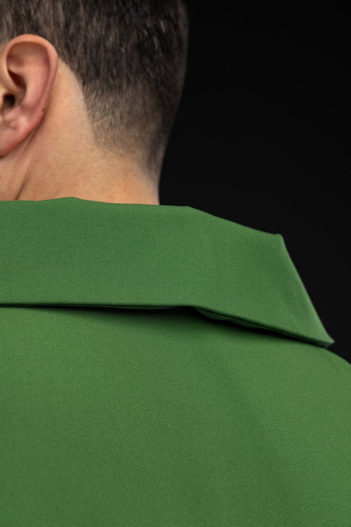 Green chasuble back view with embroidered cross and gold trim