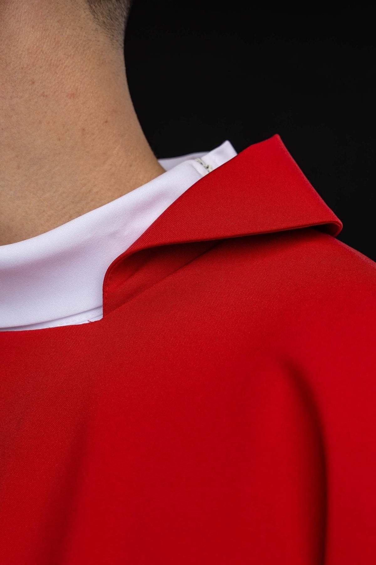 Red chasuble close-up showing wide square collar